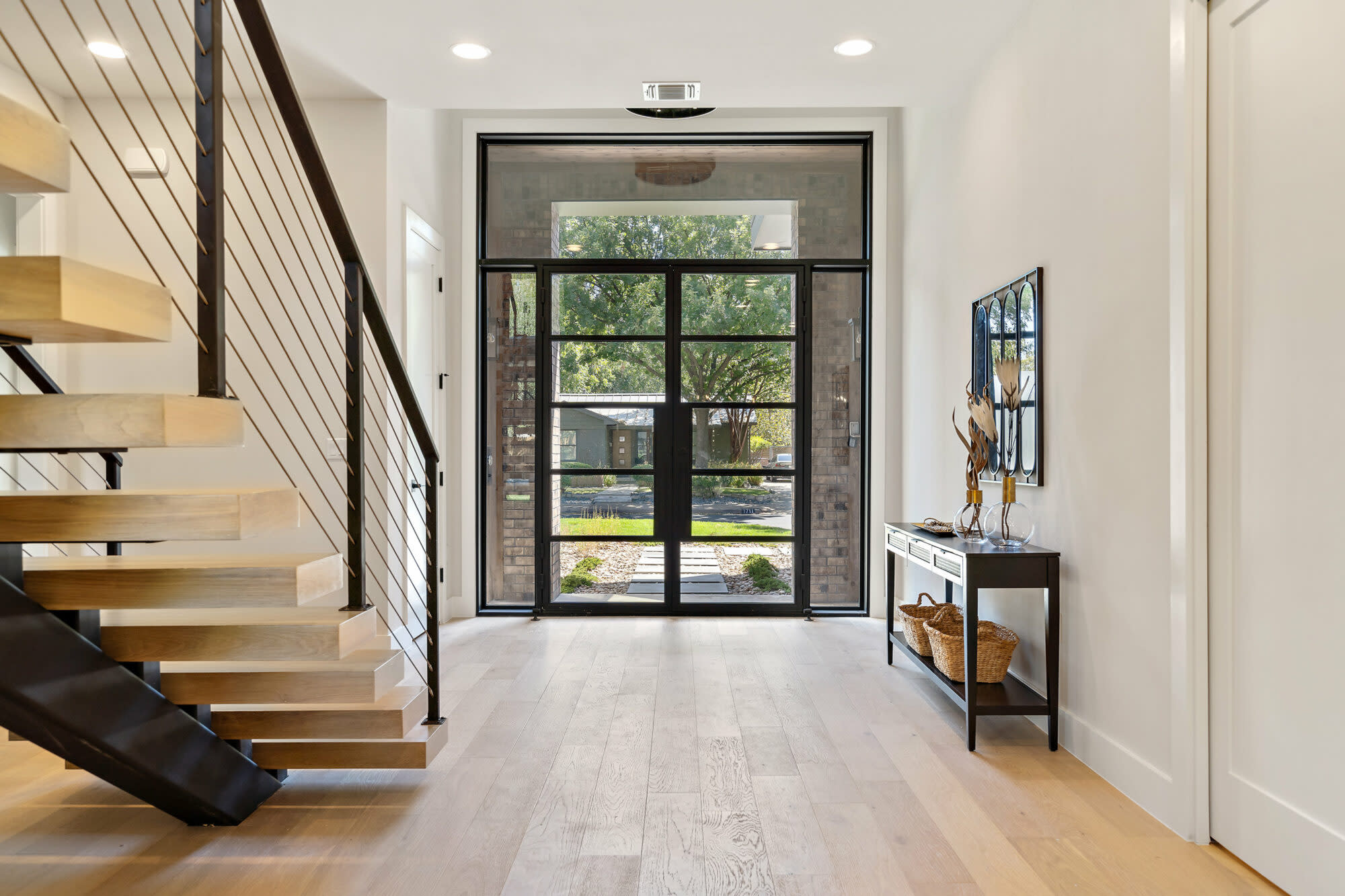 a hallway with glass doors and stairs