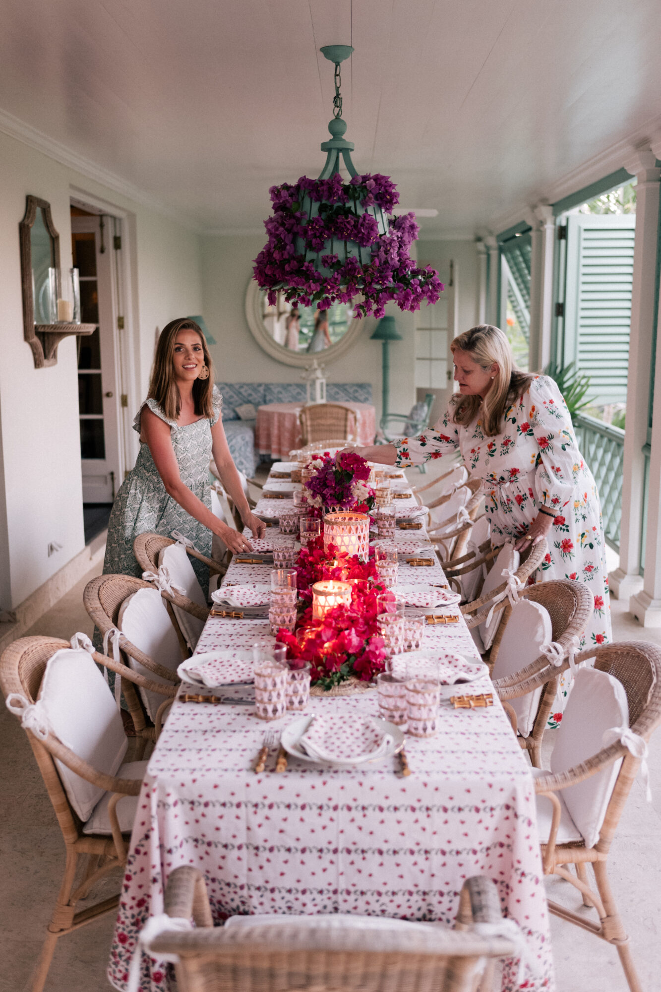 Amanda Lindroth and Julia Berolzheimer stand around the dining table.