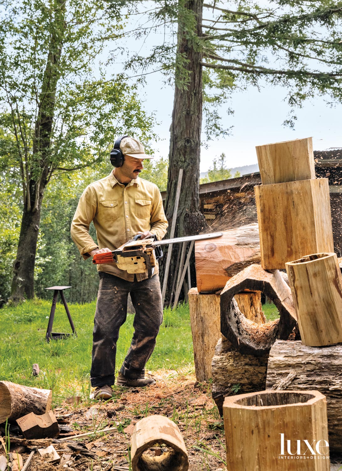 A woodworker uses a chainsaw to shape his creations.