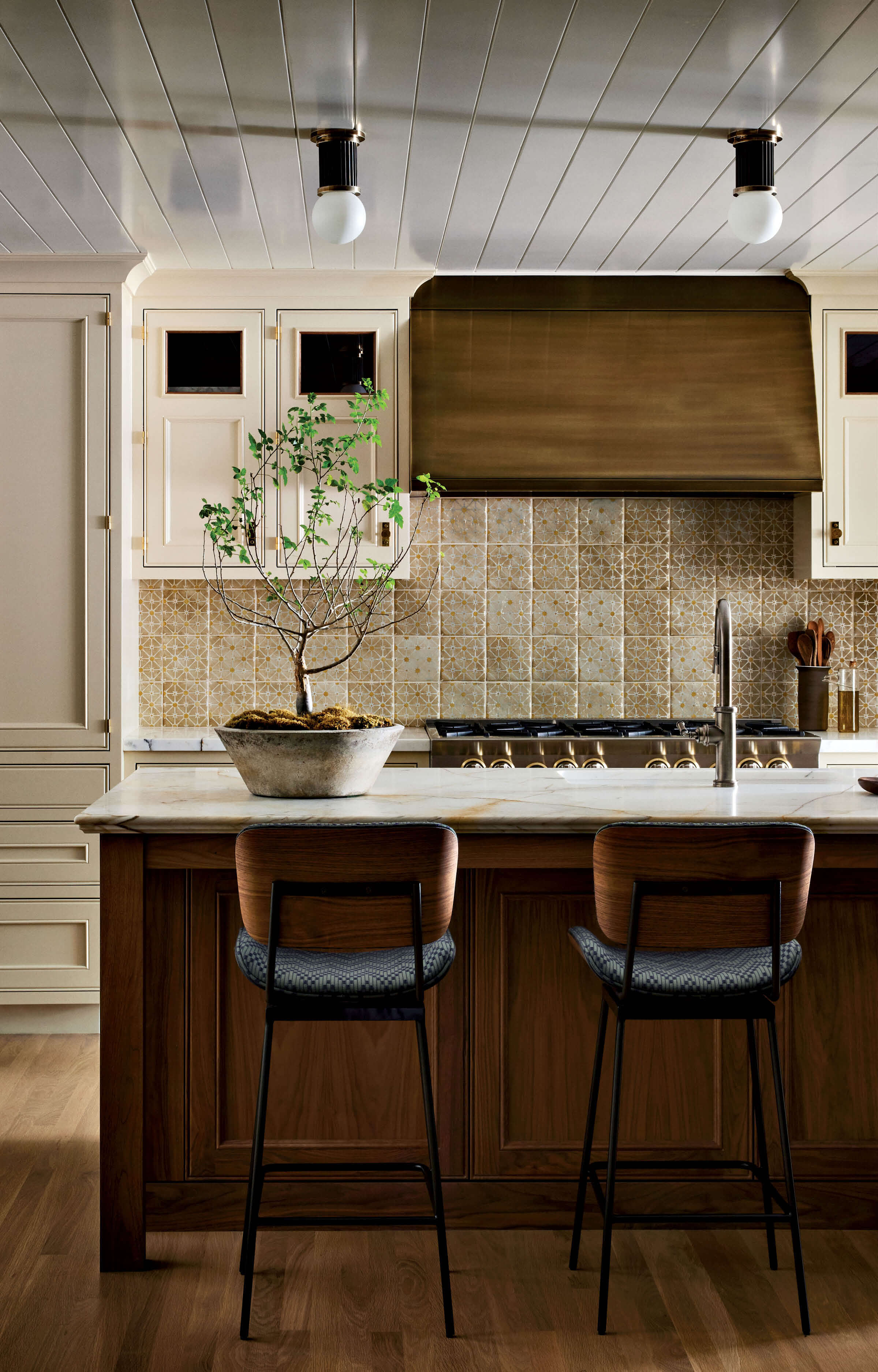 walnut kitchen island topped with Calacatta marble and urban electric co pendants 