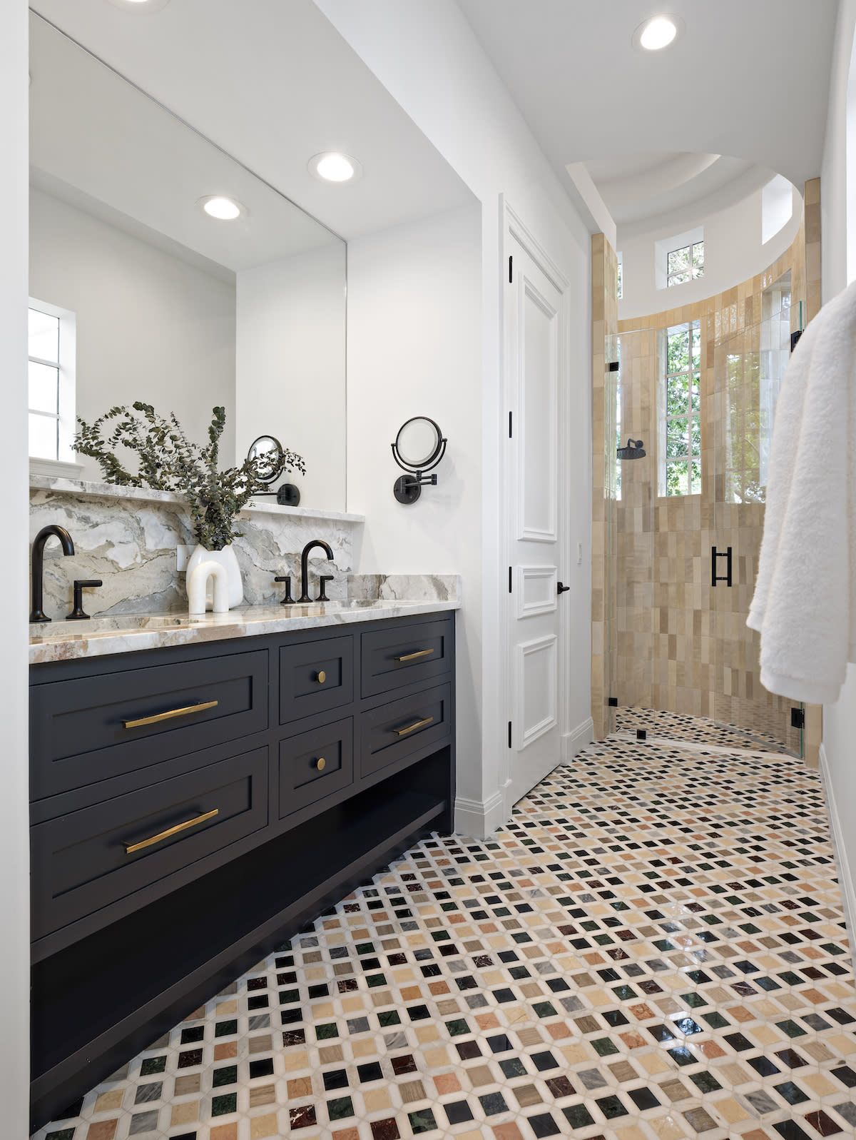 Brown vanity, white countertops, tile floor