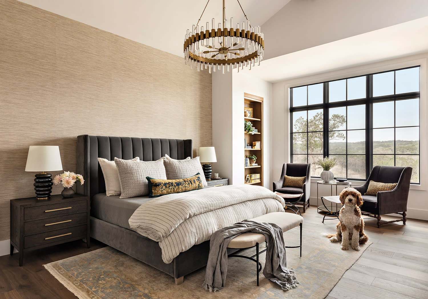 neutral primary bedroom with a gray bed and a delicate chandelier 