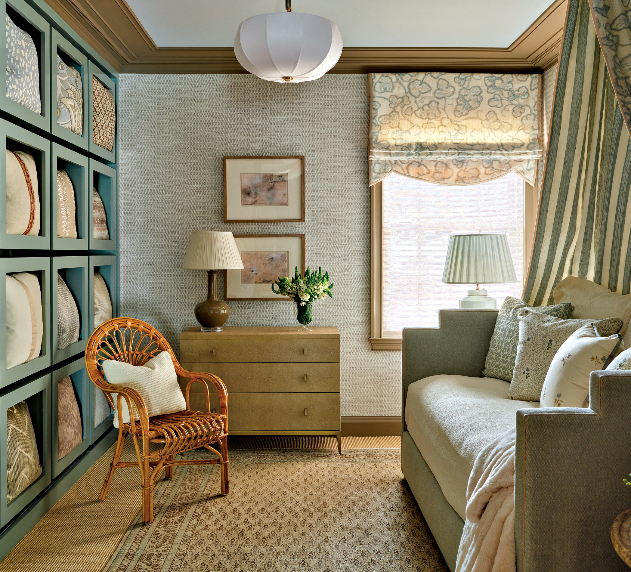 throw pillows within built in blue shelving and a day bed