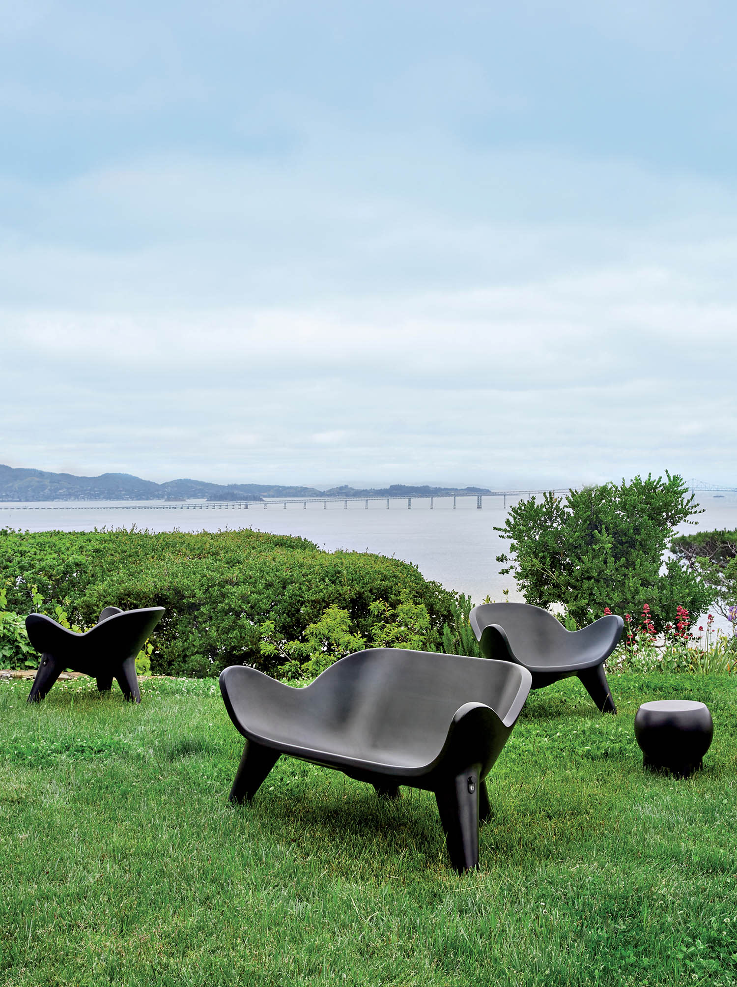 black outdoor seats next to a lake