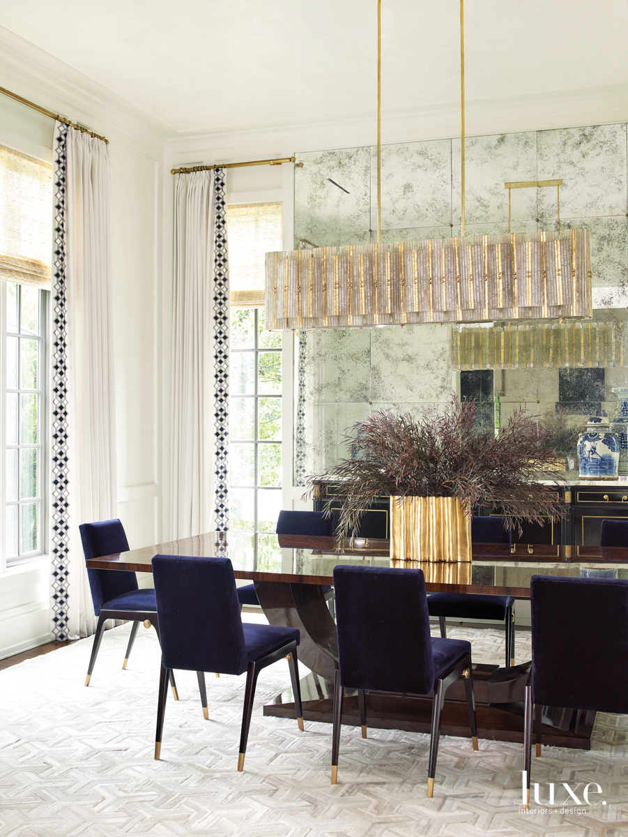 dining room with mirrored walls and glas chandelier