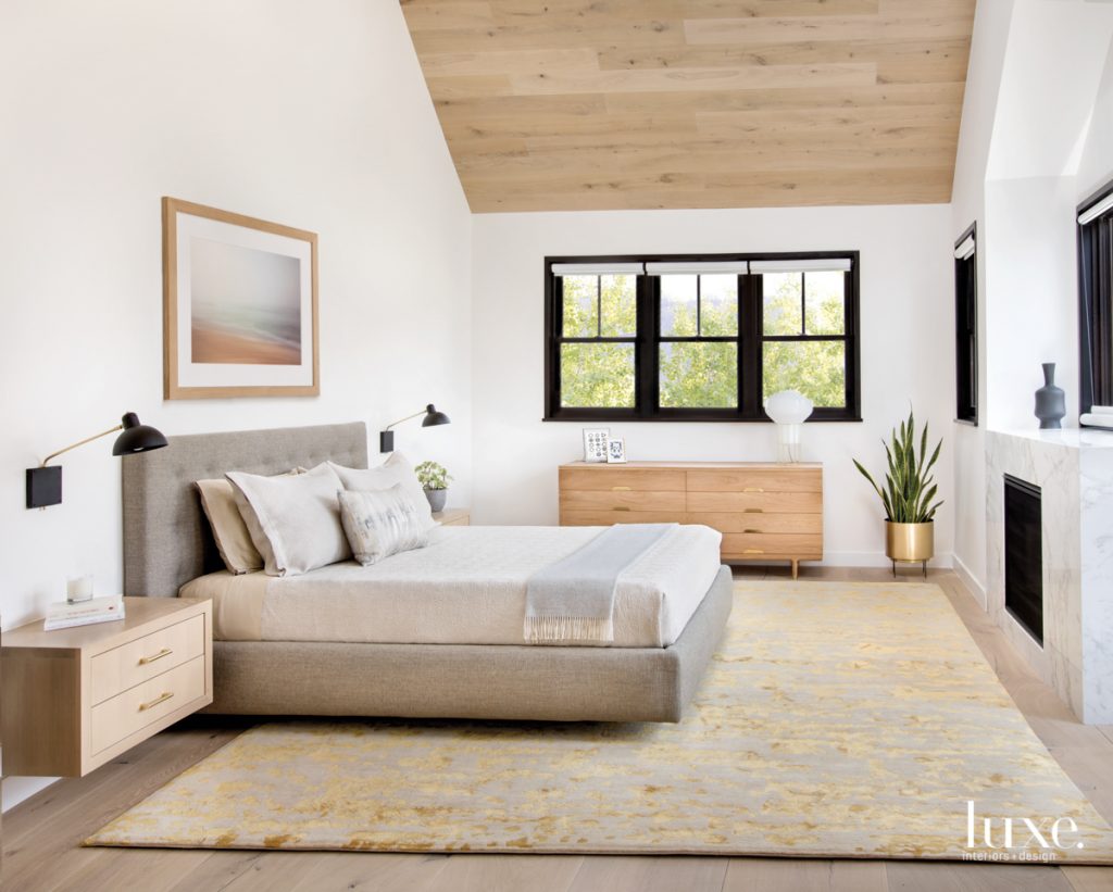 bedroom with luxurious and comfortable bed and sheets, wood ceiling and tan rug