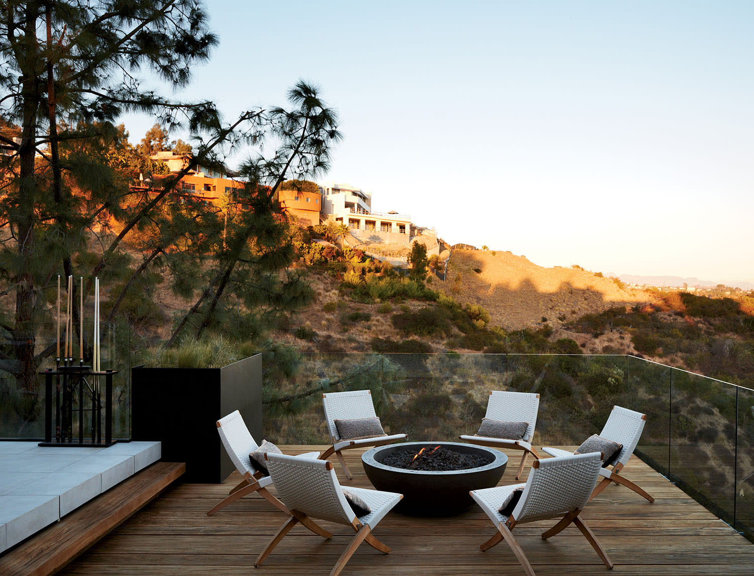 deck with a fire pit surrounded by modern seating overlooking views of California