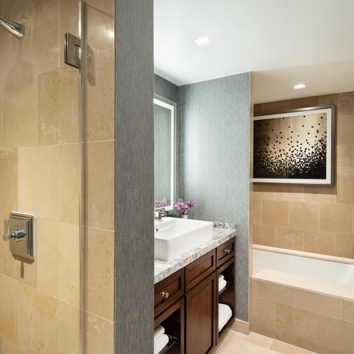 The Executive Suite touts exemplary bath amenities, including a soaking tub and marble-clad, walk-in shower.