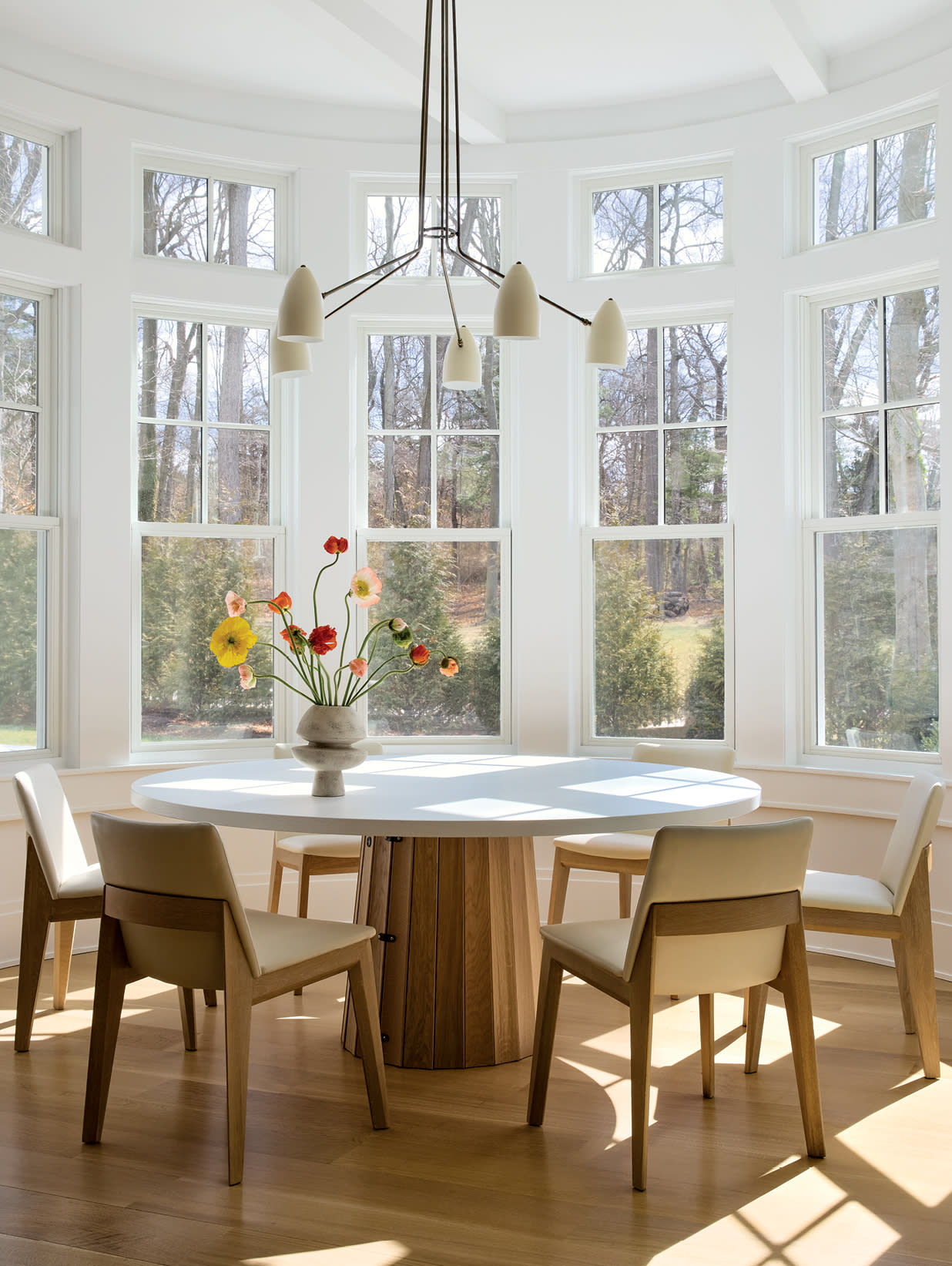 sunny breakfast nook surrounded by bay windows