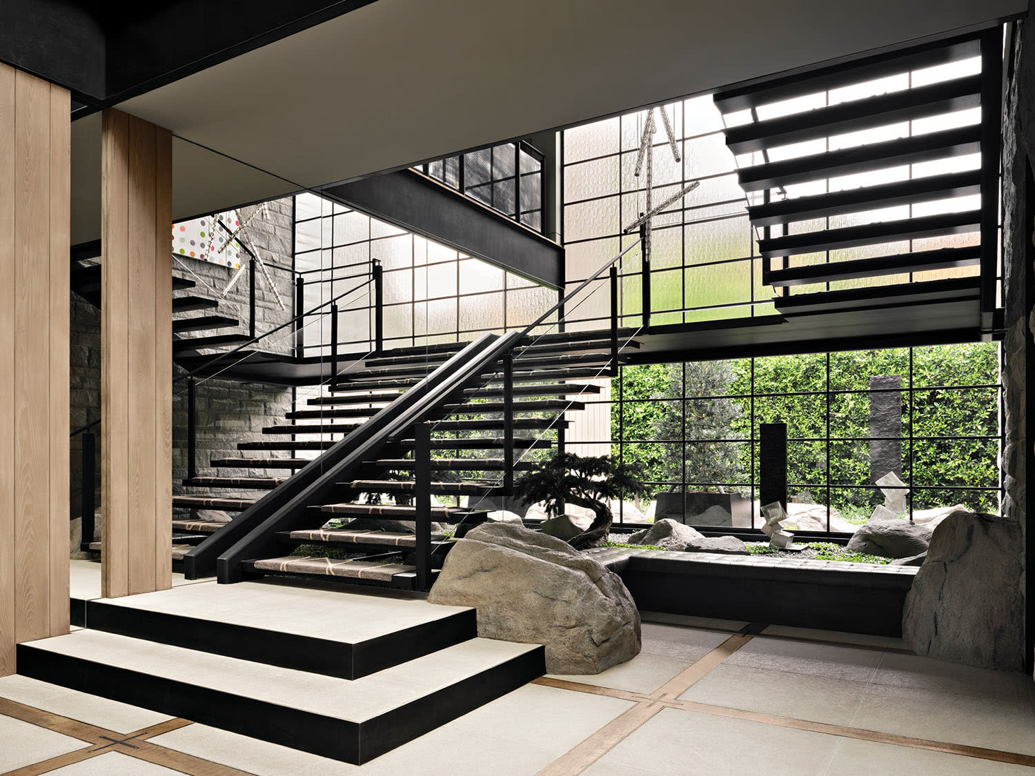 industrial-style stairway flanked by a Zen garden in a California home