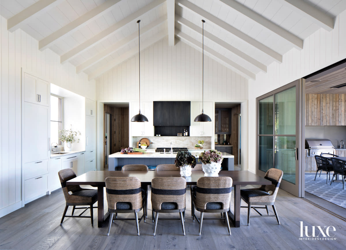 white dining room and kitchen with high ceilings