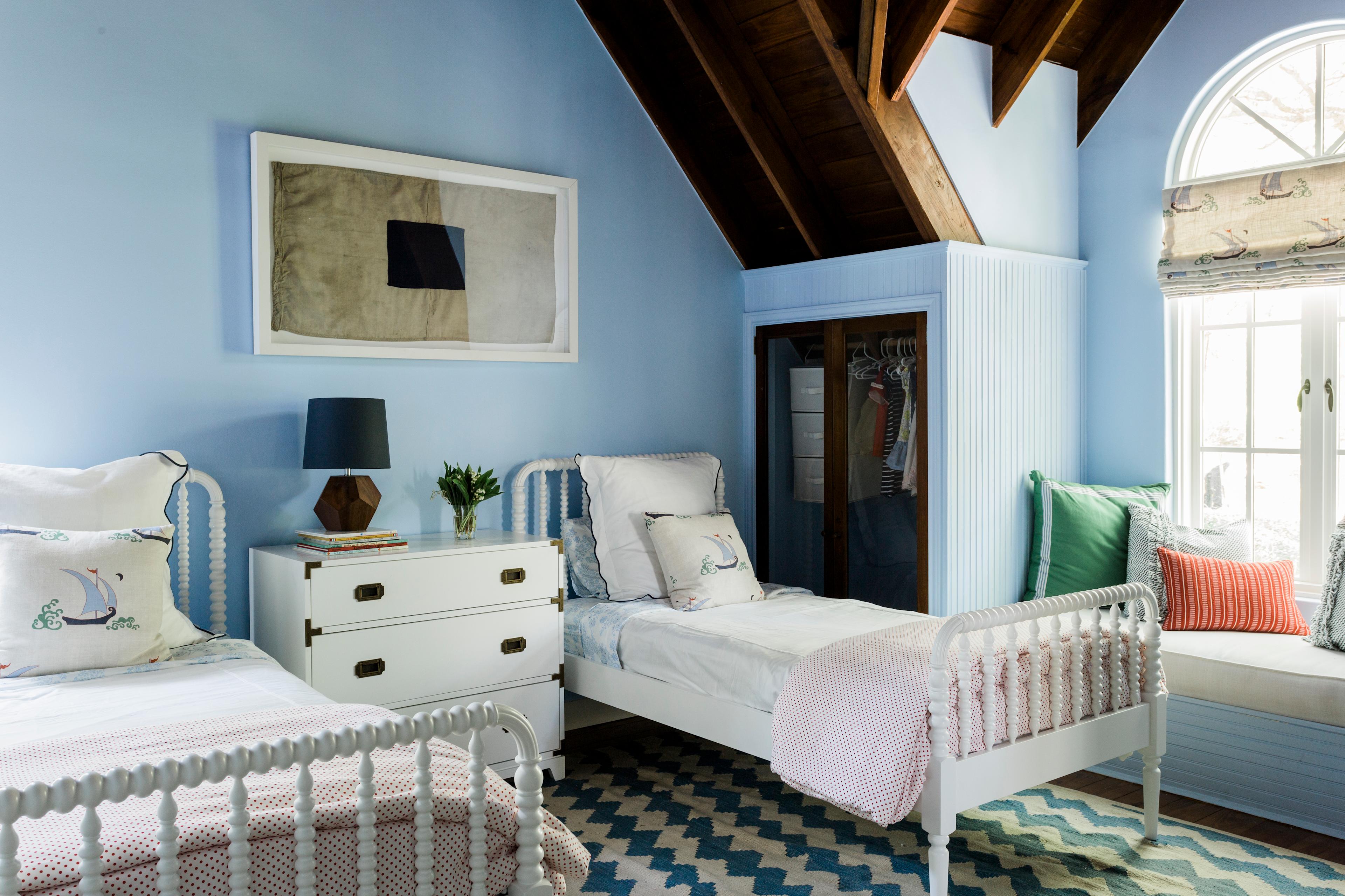 blue bedroom with two white twin beds