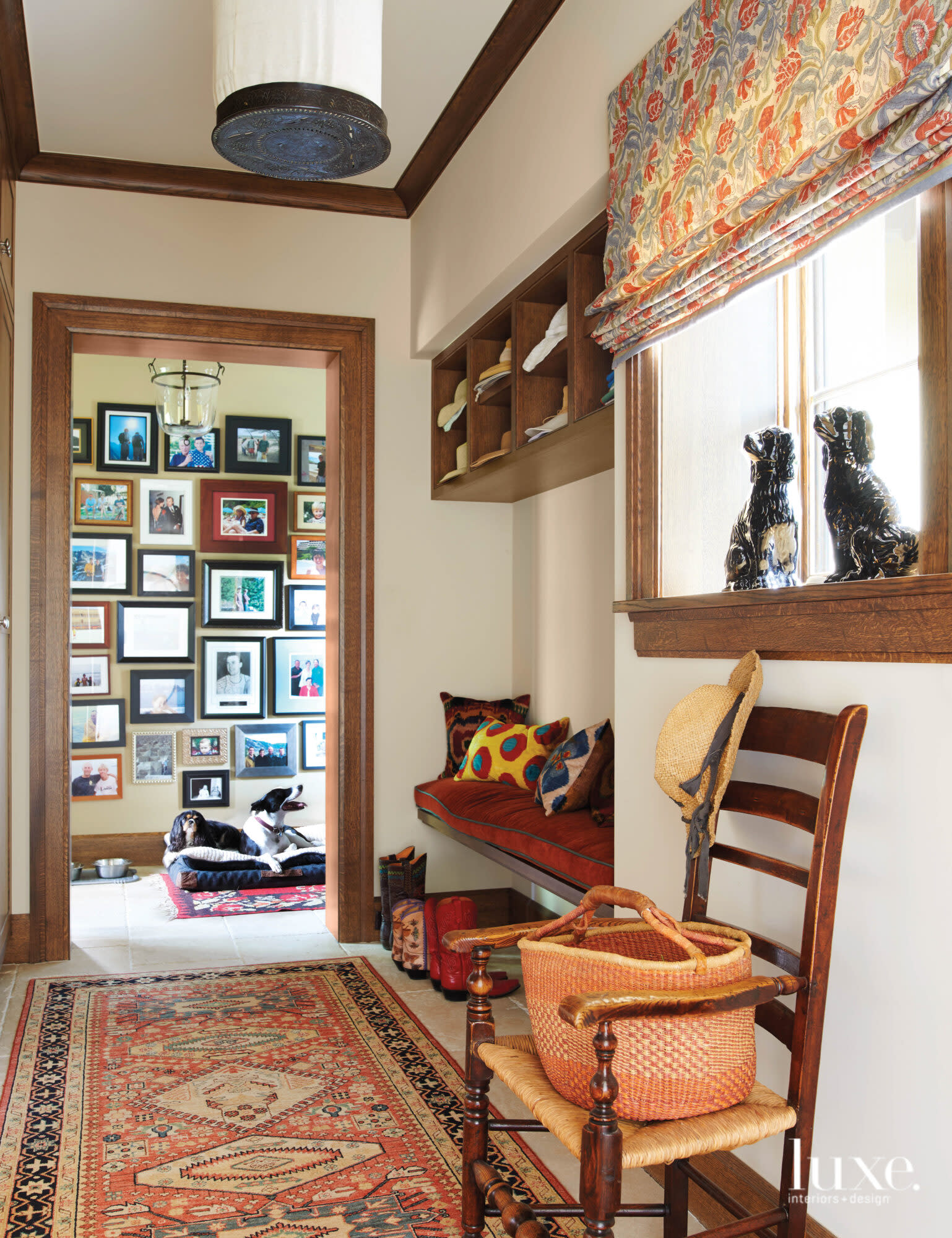 A mudroom features a bench and antique chair.