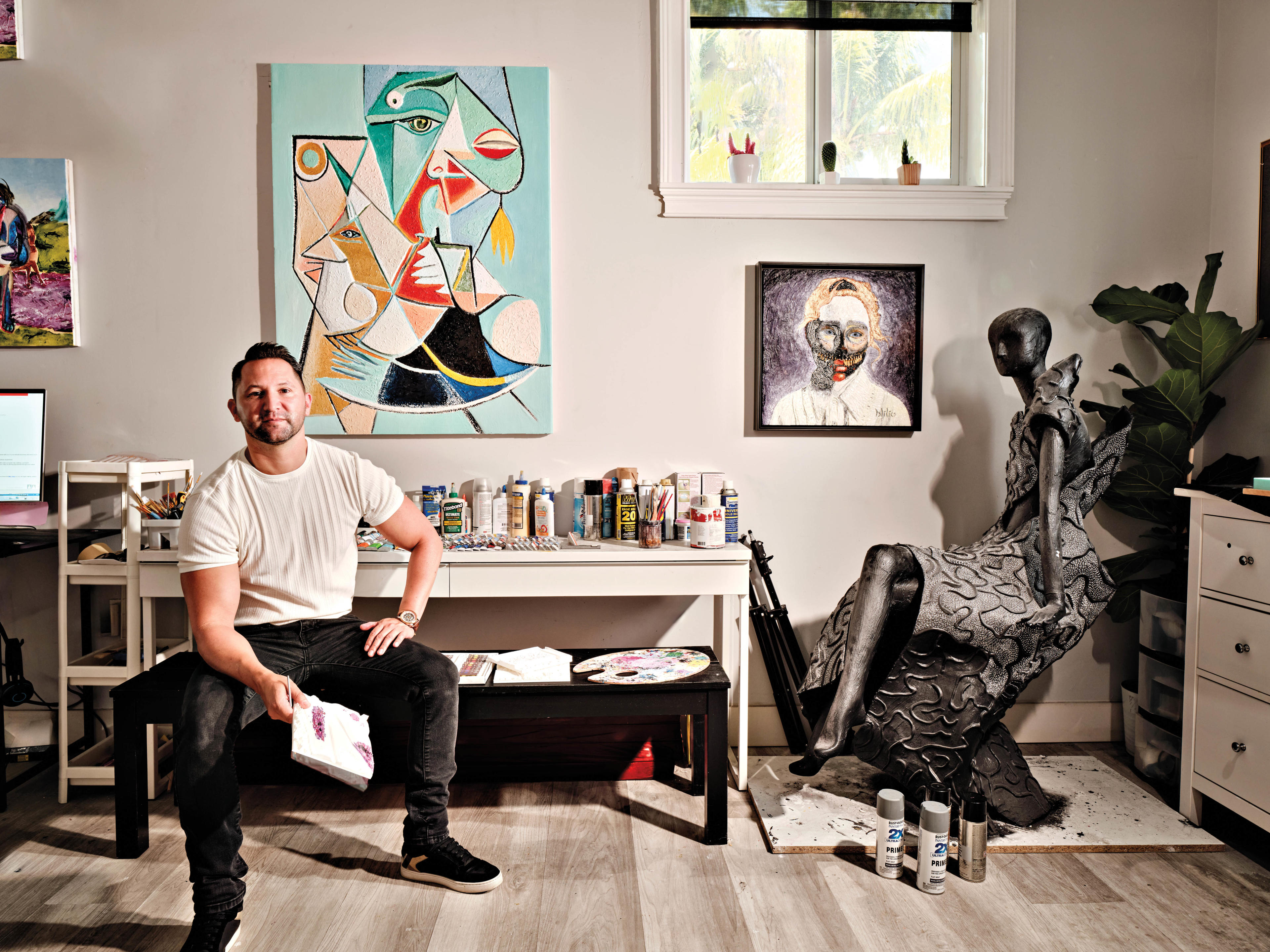 artist Daniel Acero sits in his studio