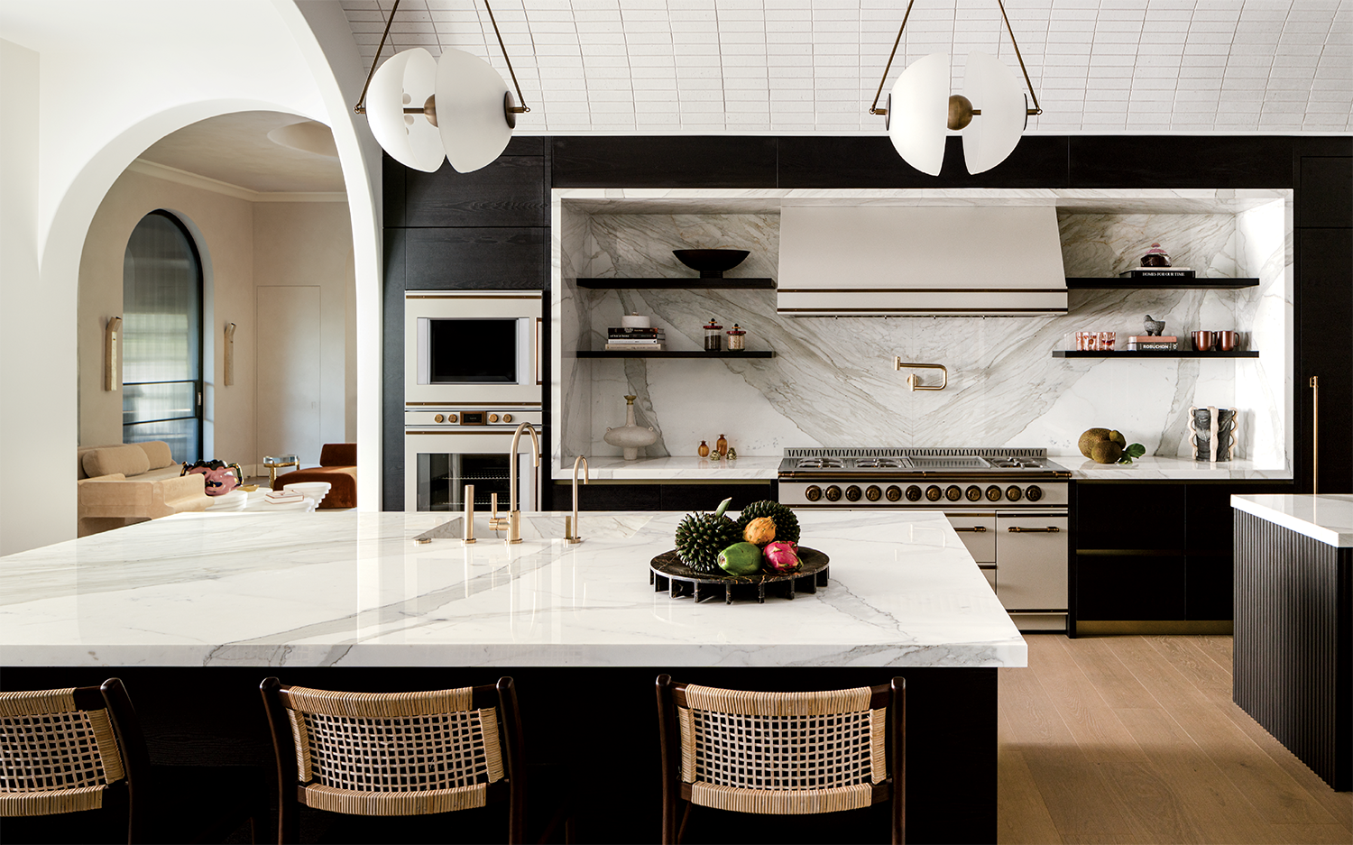 modern kitchen with black cabinetry and marble countertops