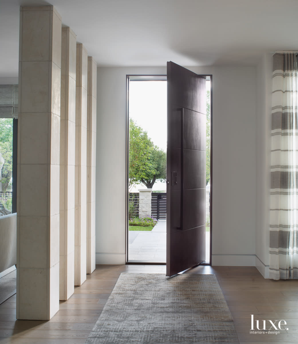 limestone columns entryway with walnut front door