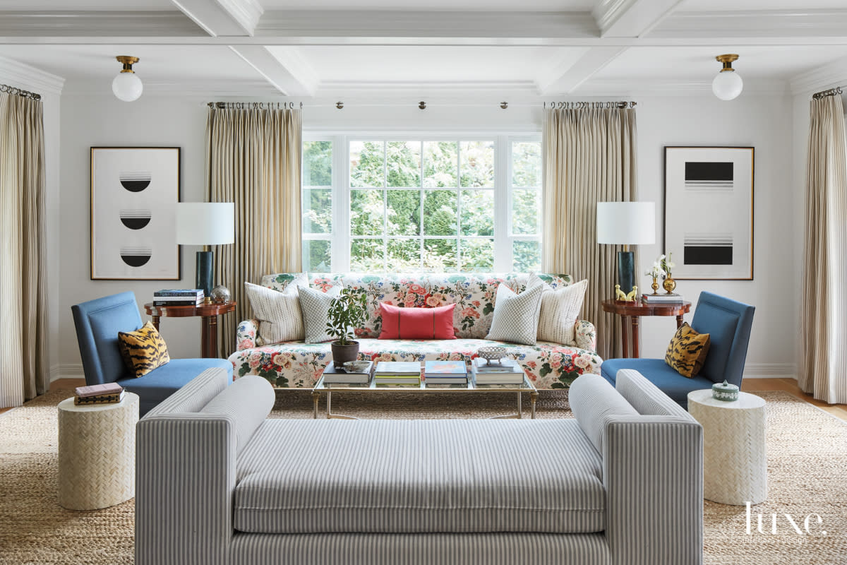 Another seating area in the living room which features a floral couch.