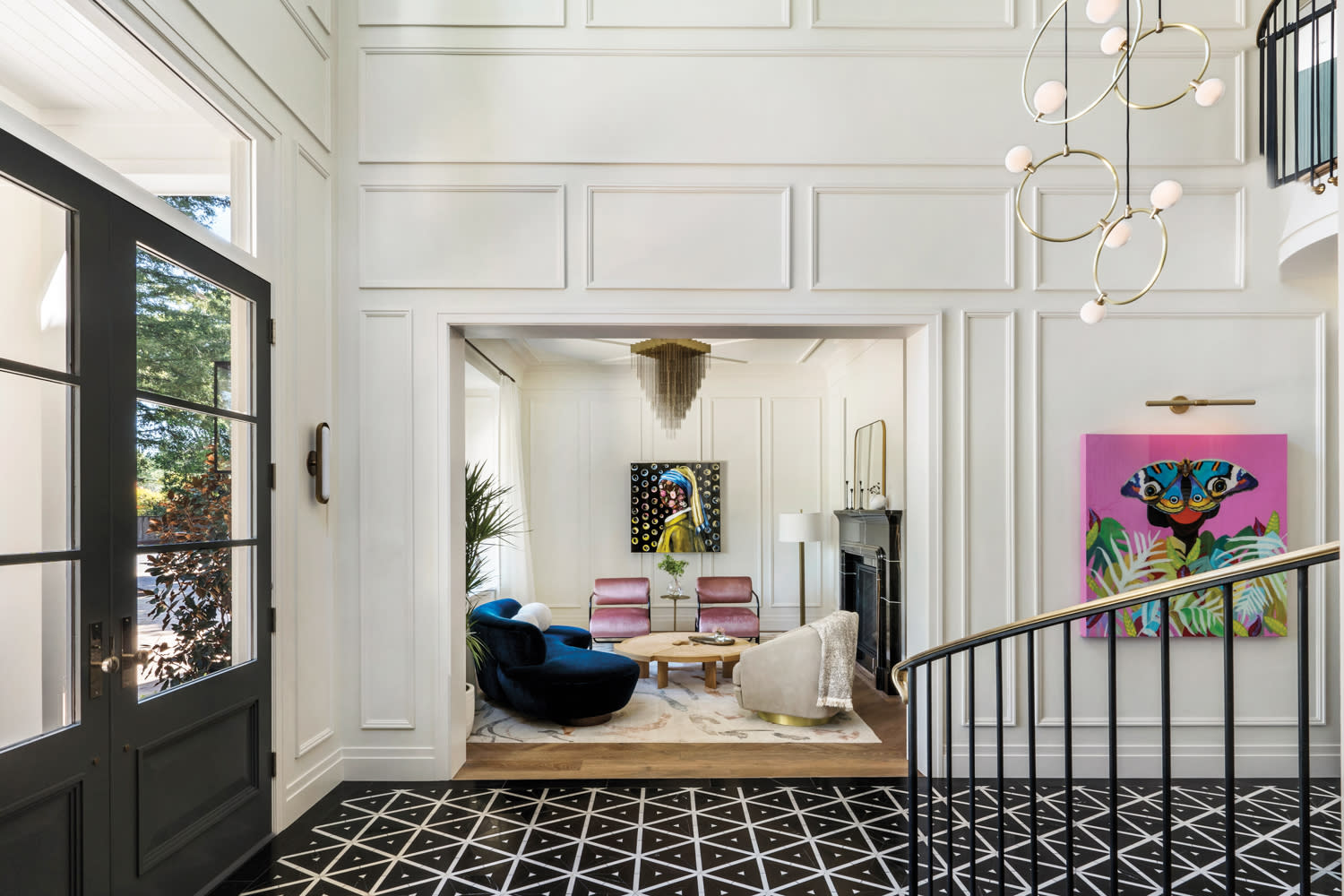 The floor of a home's entry is covered in bold black-and-white tile.