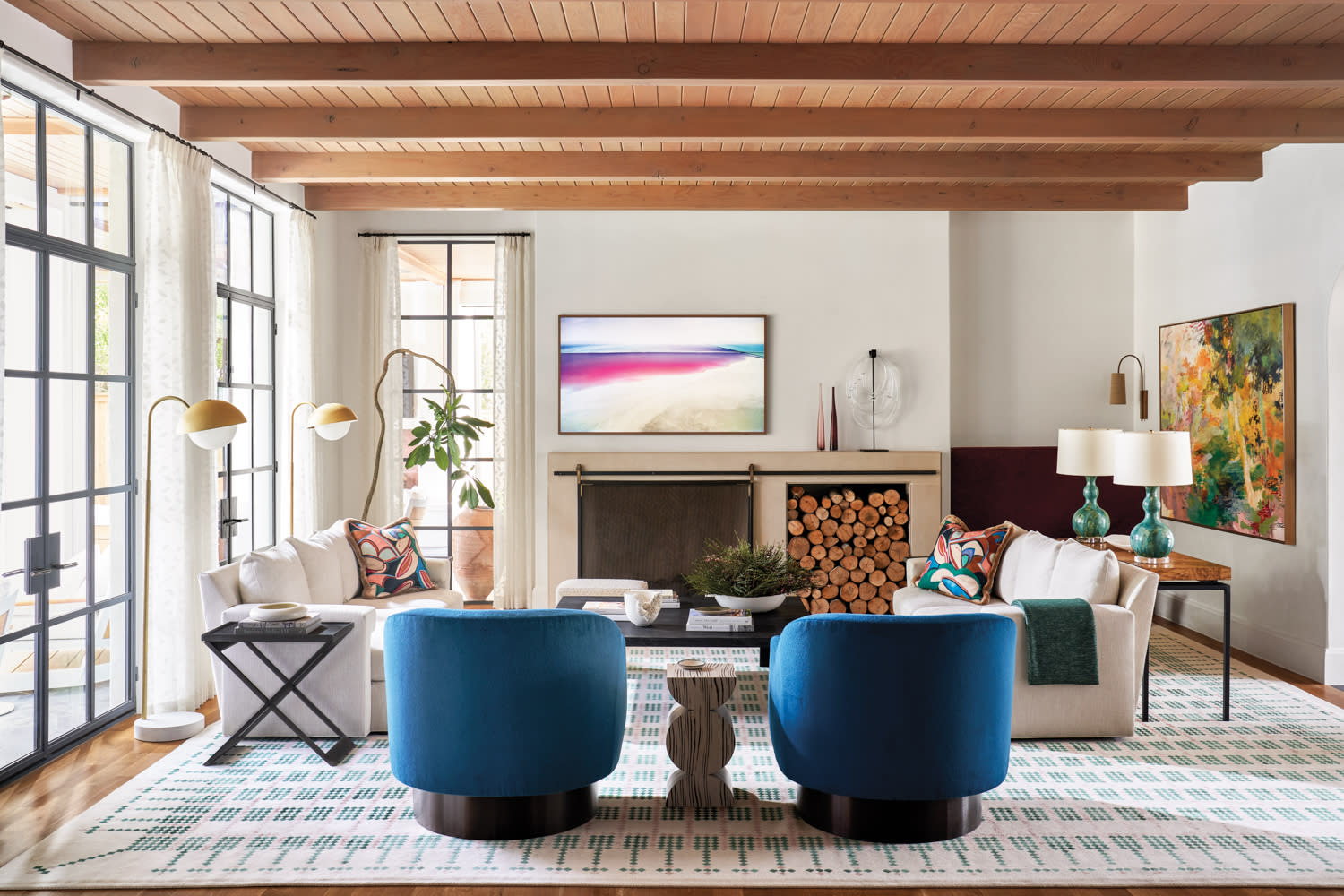 living room featuring wooden ceiling, blue swivel chairs, white floor lamps and a white rug