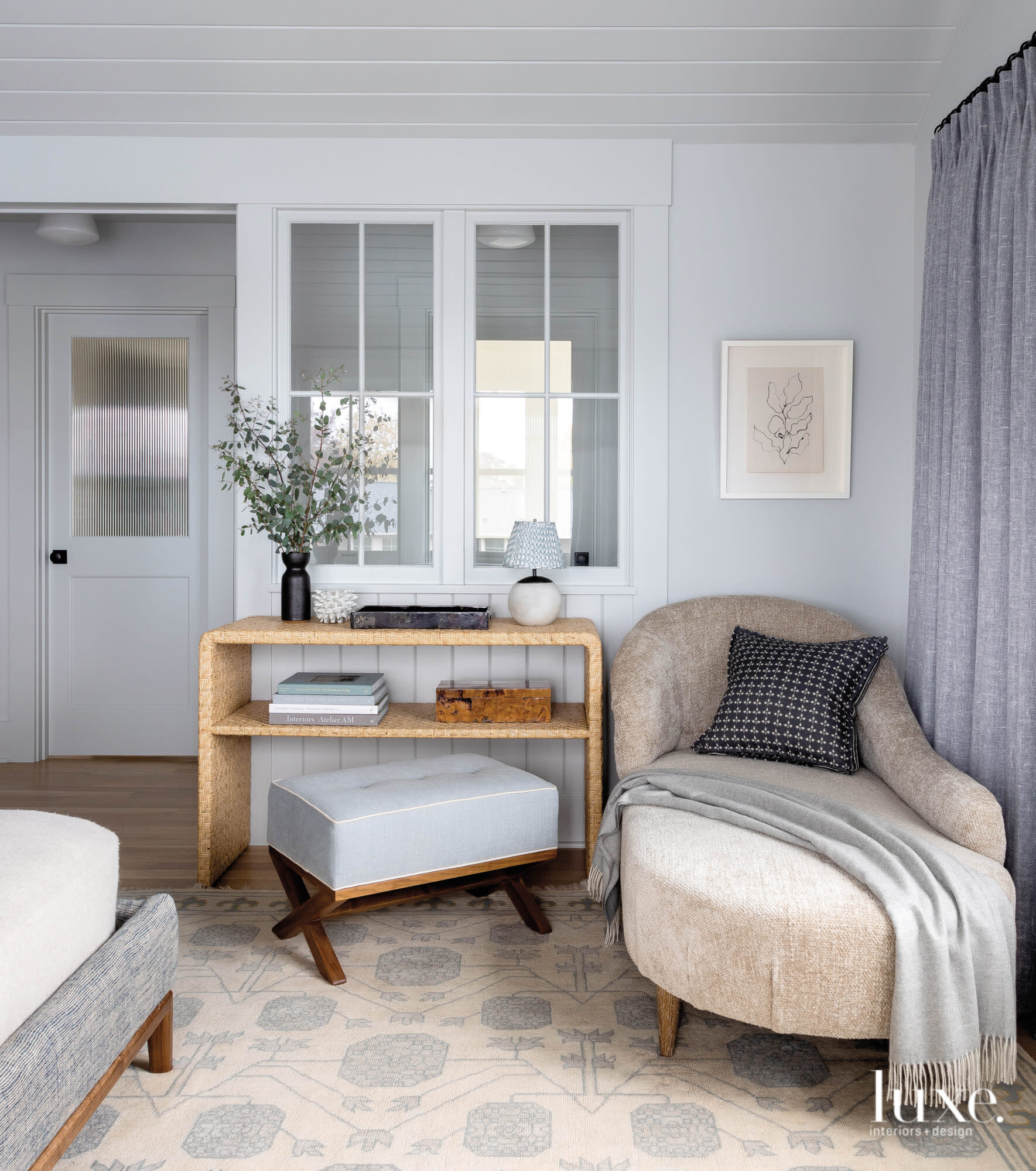Master bedroom with vignette of chaise and shelving