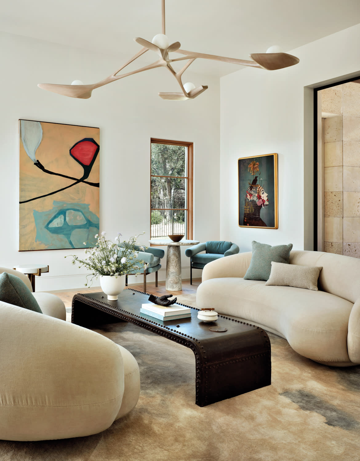 living room with curved sofas and modern art