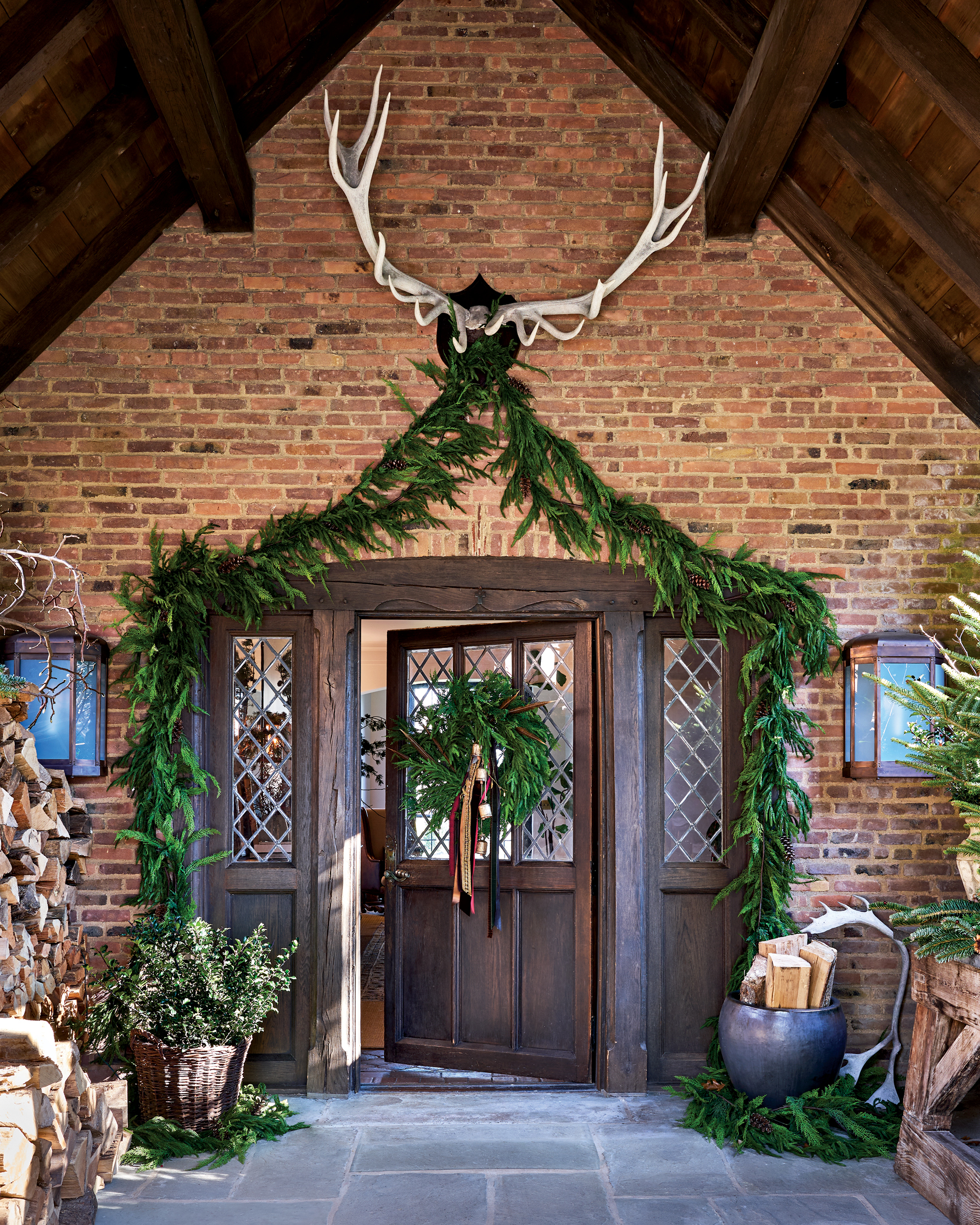 holiday greenery draped over wood door way and antlers