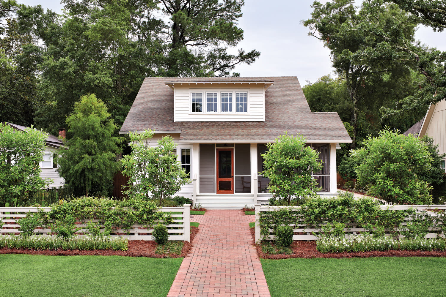 exterior of a cottage in Alabama with boxwoods lining the path to the door