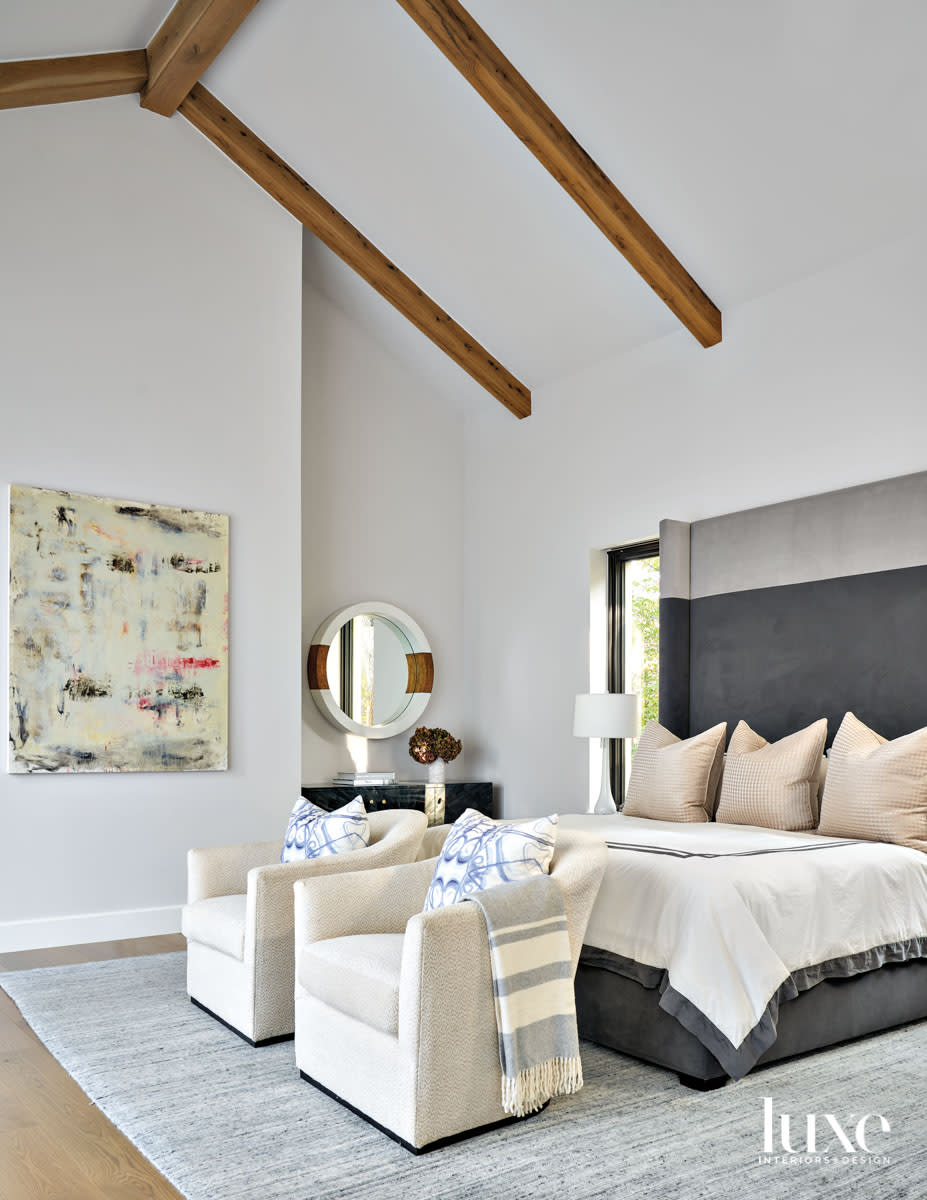 white bedroom with gray velvet headboard