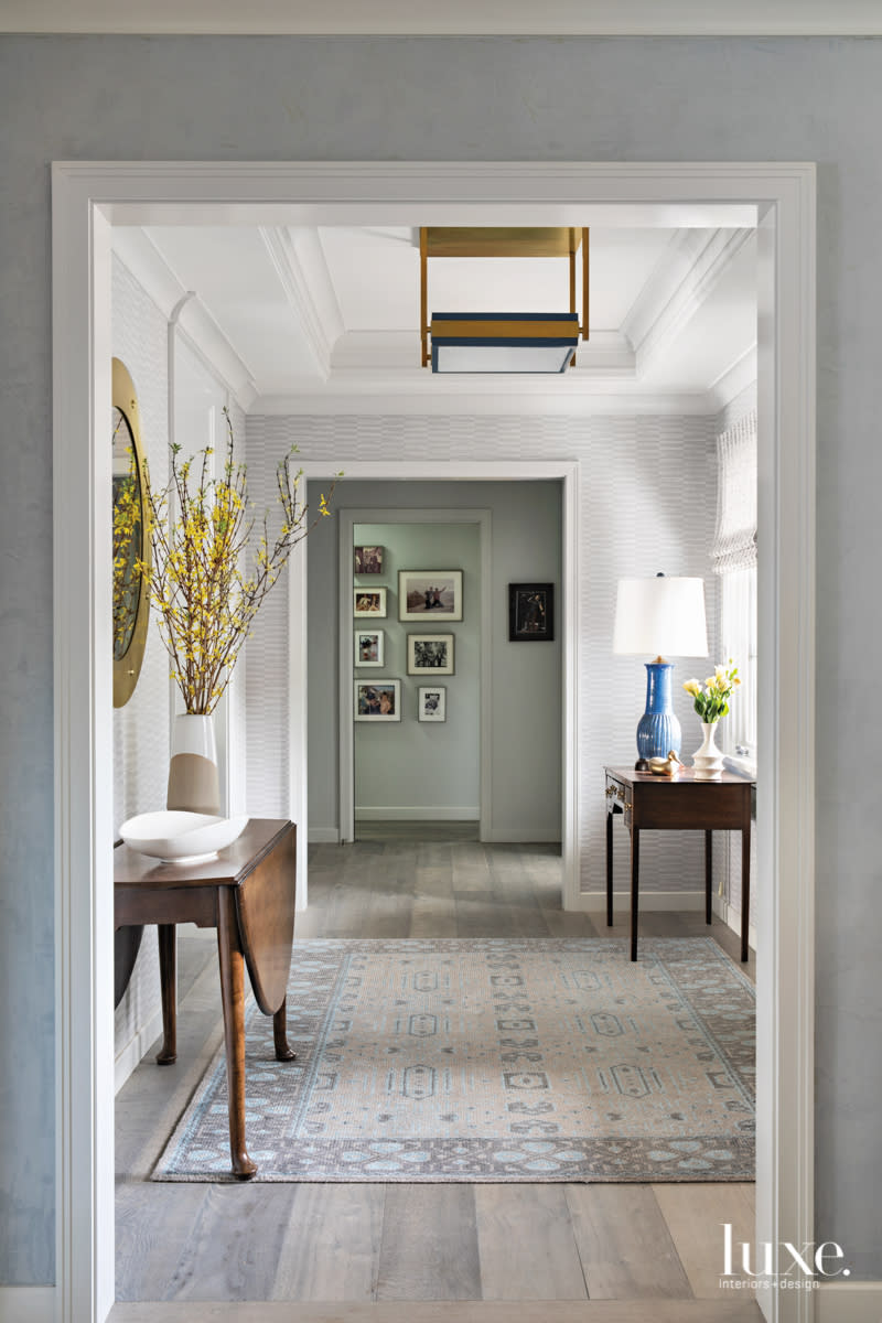 entry wiith philip jeffries wallcovering and heirloom tables