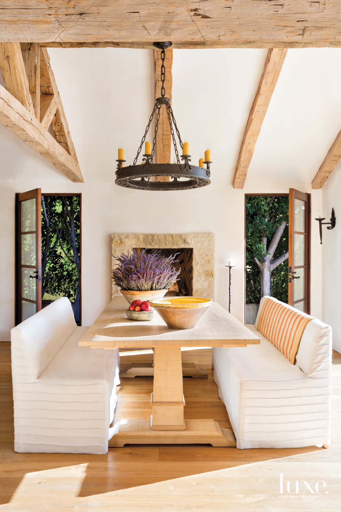 View of dining area with fireplace and slipcovered benches