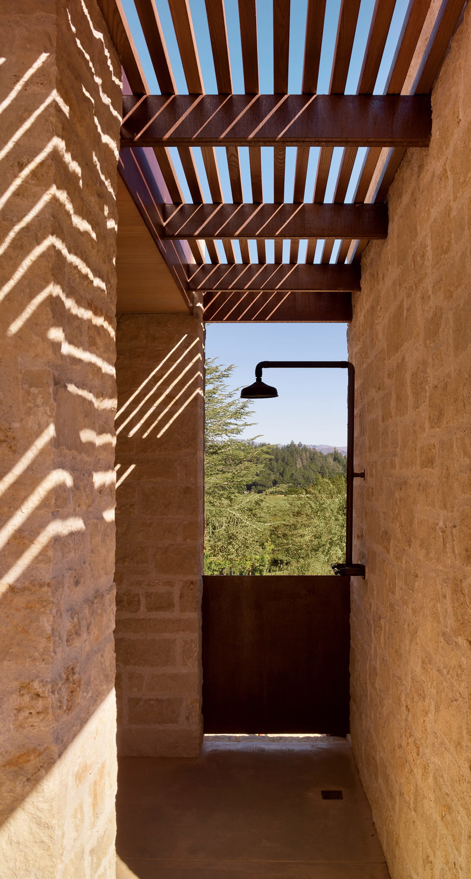 wood-slat trellis covers a pool house shower