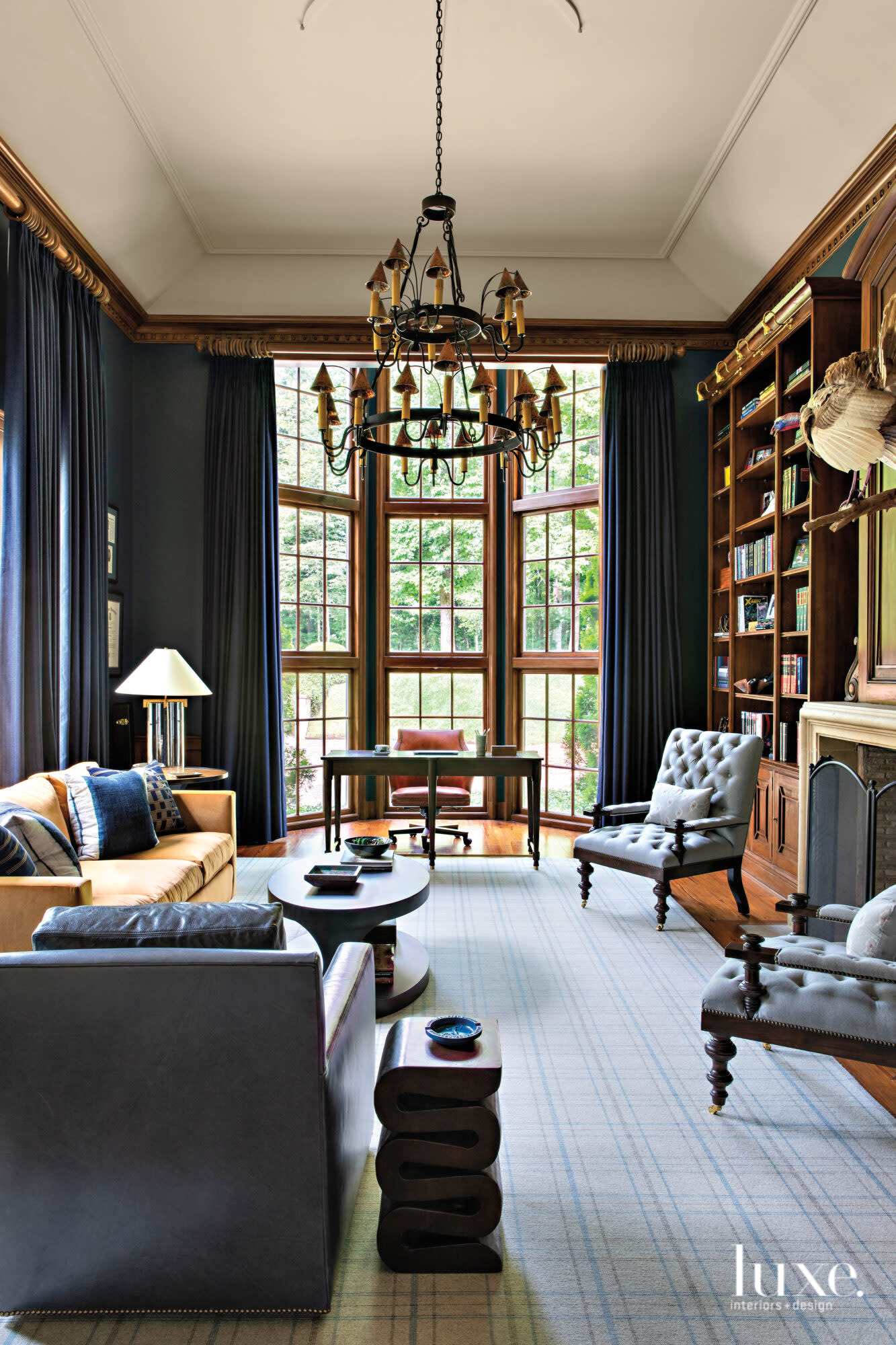 Library with desk, comfortable seating and fireplace