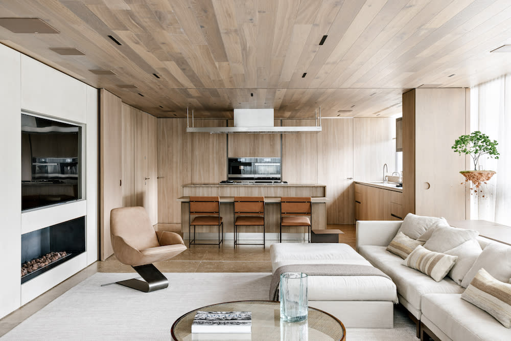 A contemporary living room featuring elegant European oak floors and a cozy fireplace, creating a warm and inviting atmosphere.