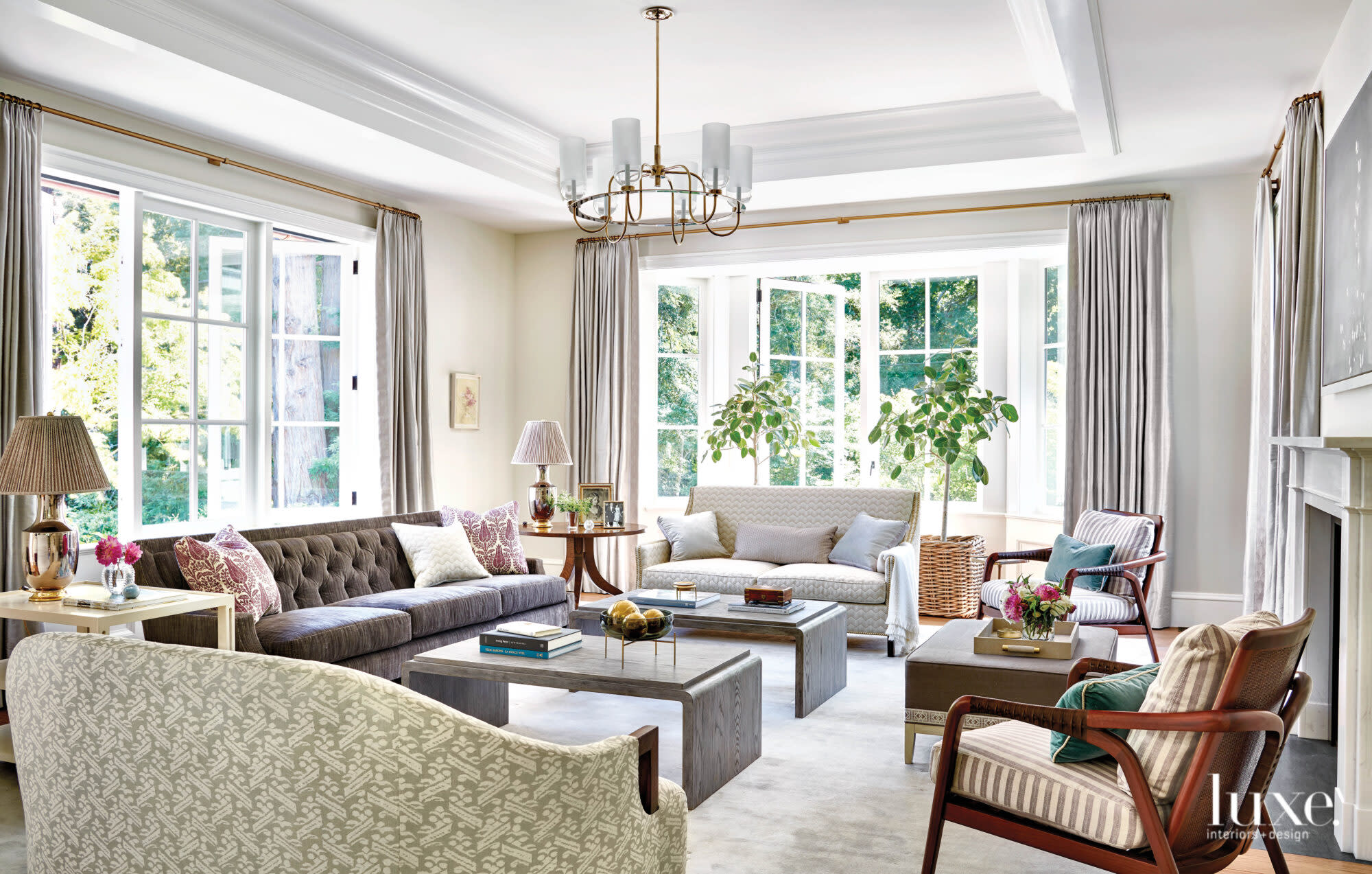 The living area has ample seating with three sofas and a pair of armchairs.