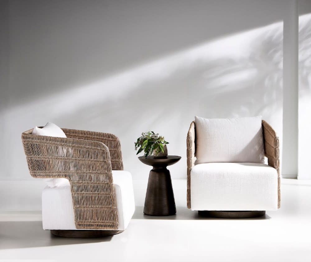 Two chairs with wicker and white cushions, creating a comfortable seating arrangement.