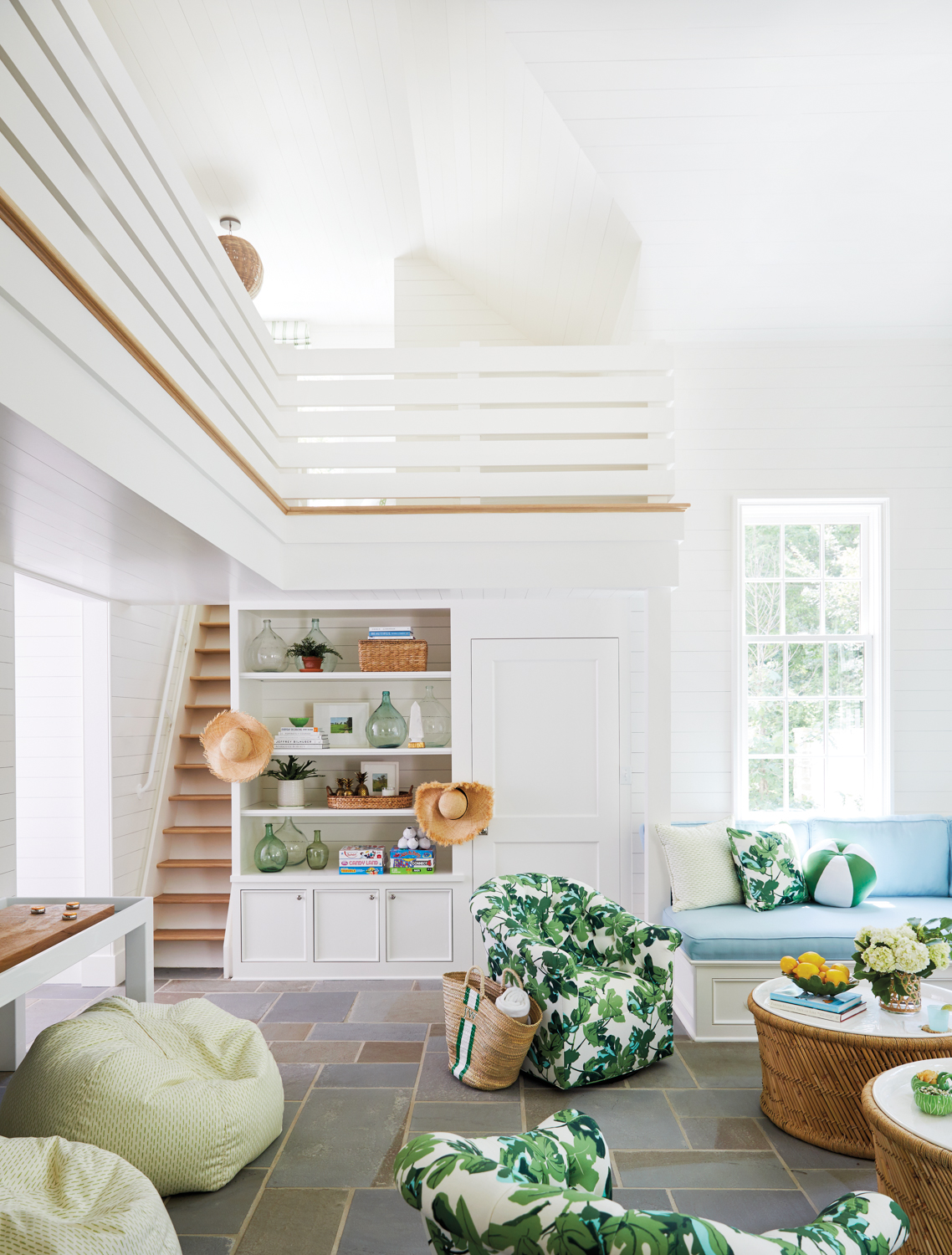 interior of a pool house with white walls, shelves and floral chairs