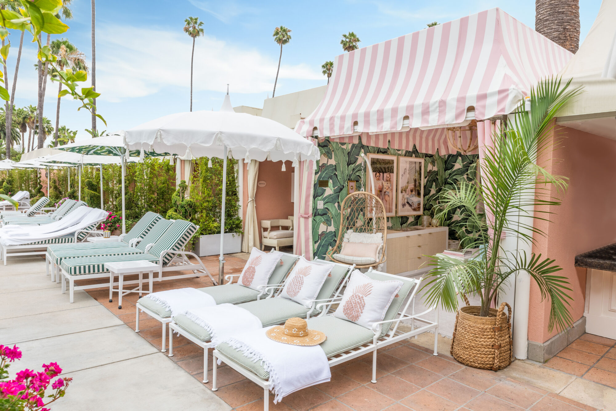 Tall palm trees poke out of the backdrop behind the retro cabana