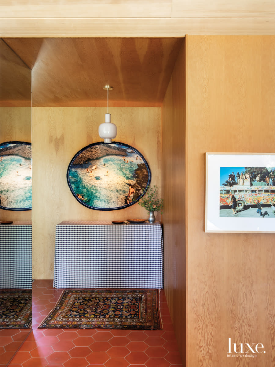 Entry way with illuminated photograph and gingham covered table