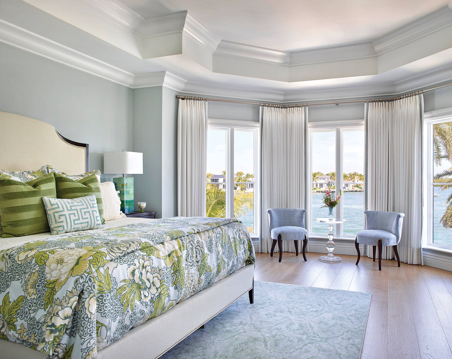 stately guest bedroom with a bay window
