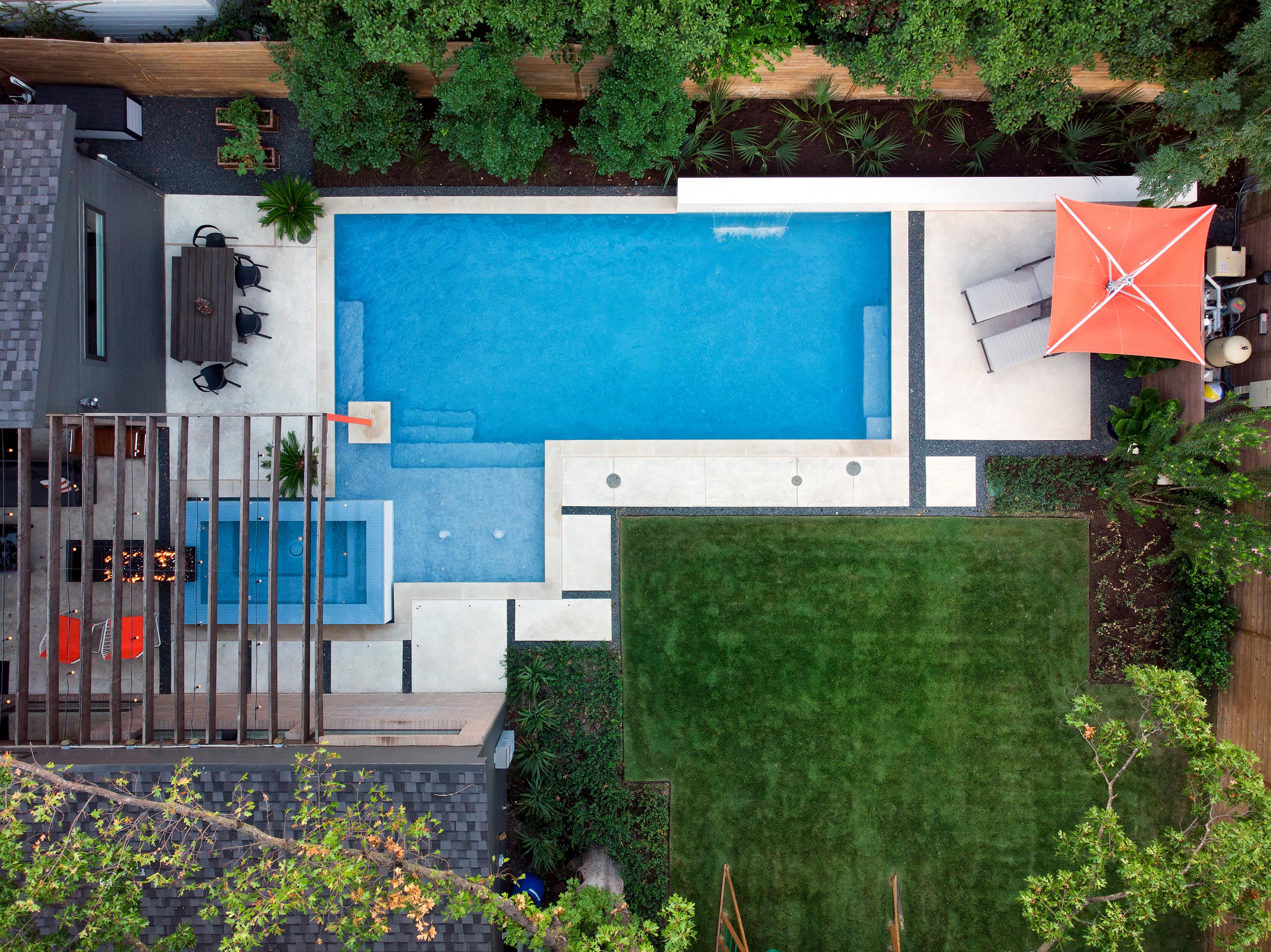 Top-down view of modern backyard with rectangular pool