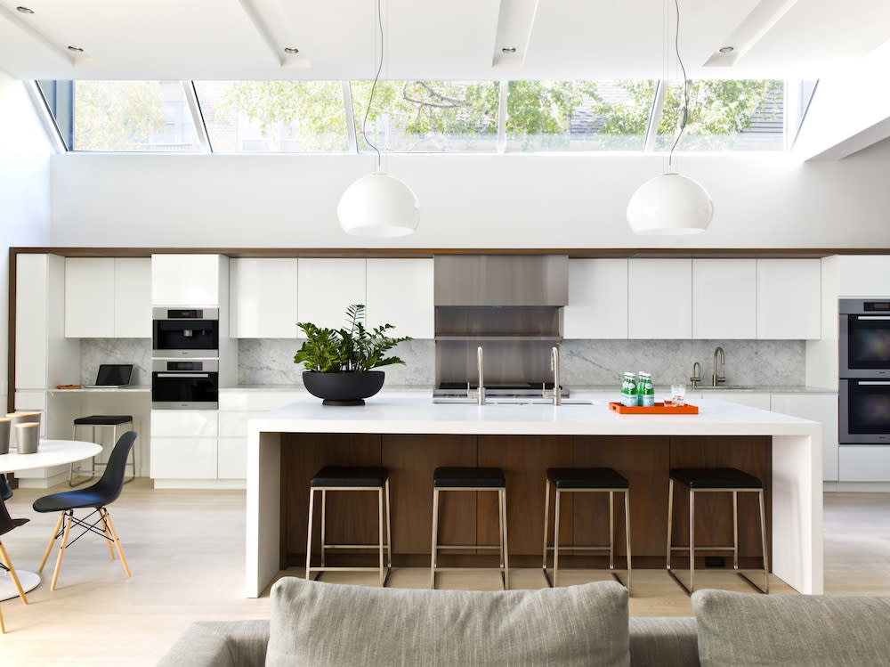 White, contemporary kitchen with skylights