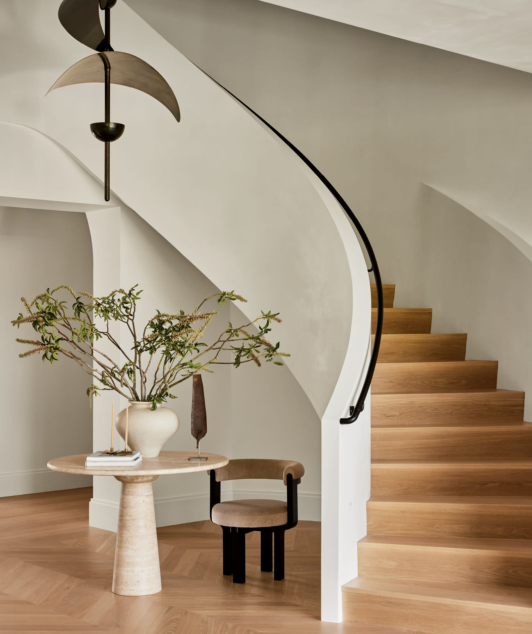 curved plaster staircase in the entry of a Connecticut home