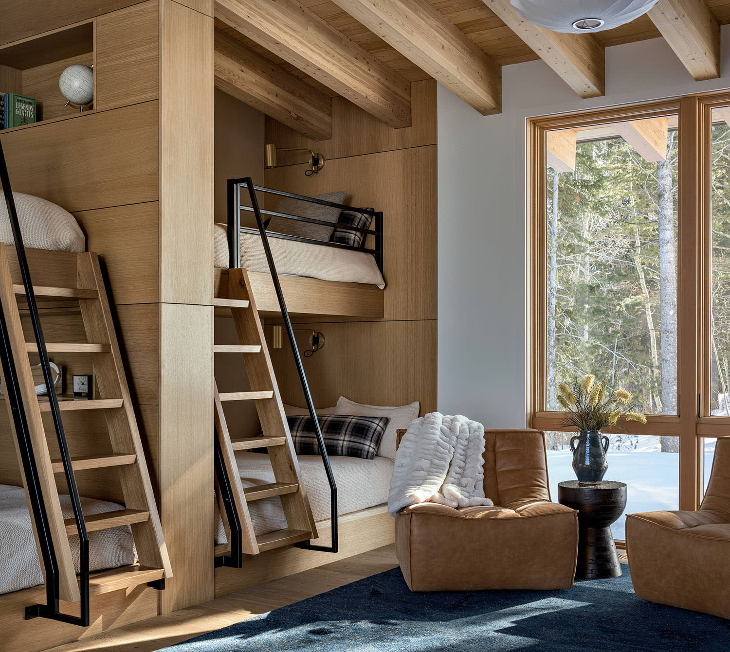 Two pairs of bunk beds, with matching ladders and plaid pillows, set up side-by-side in a bedroom.