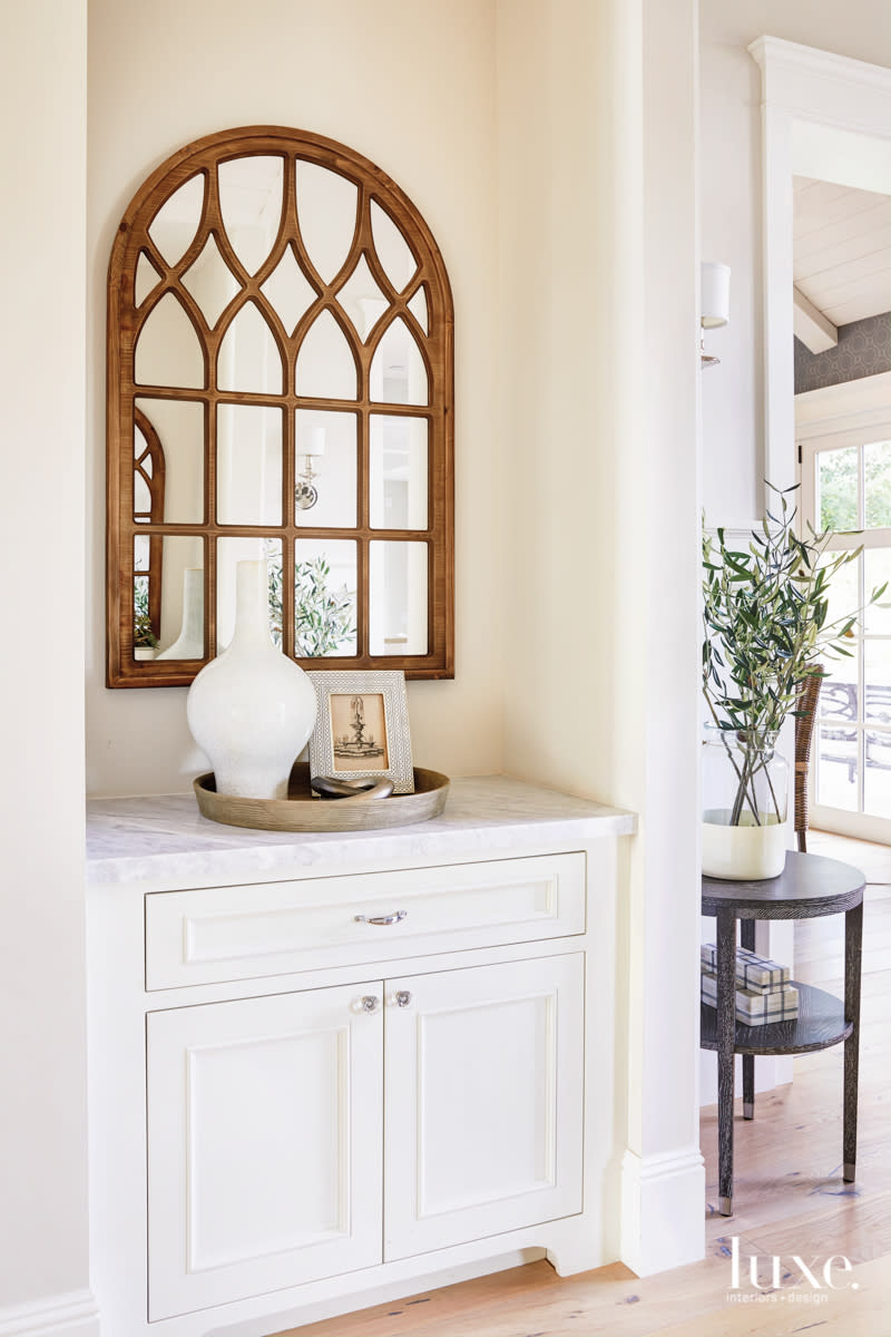 Off the entry, a built-in chest creates another place for the family to display its collected pieces.