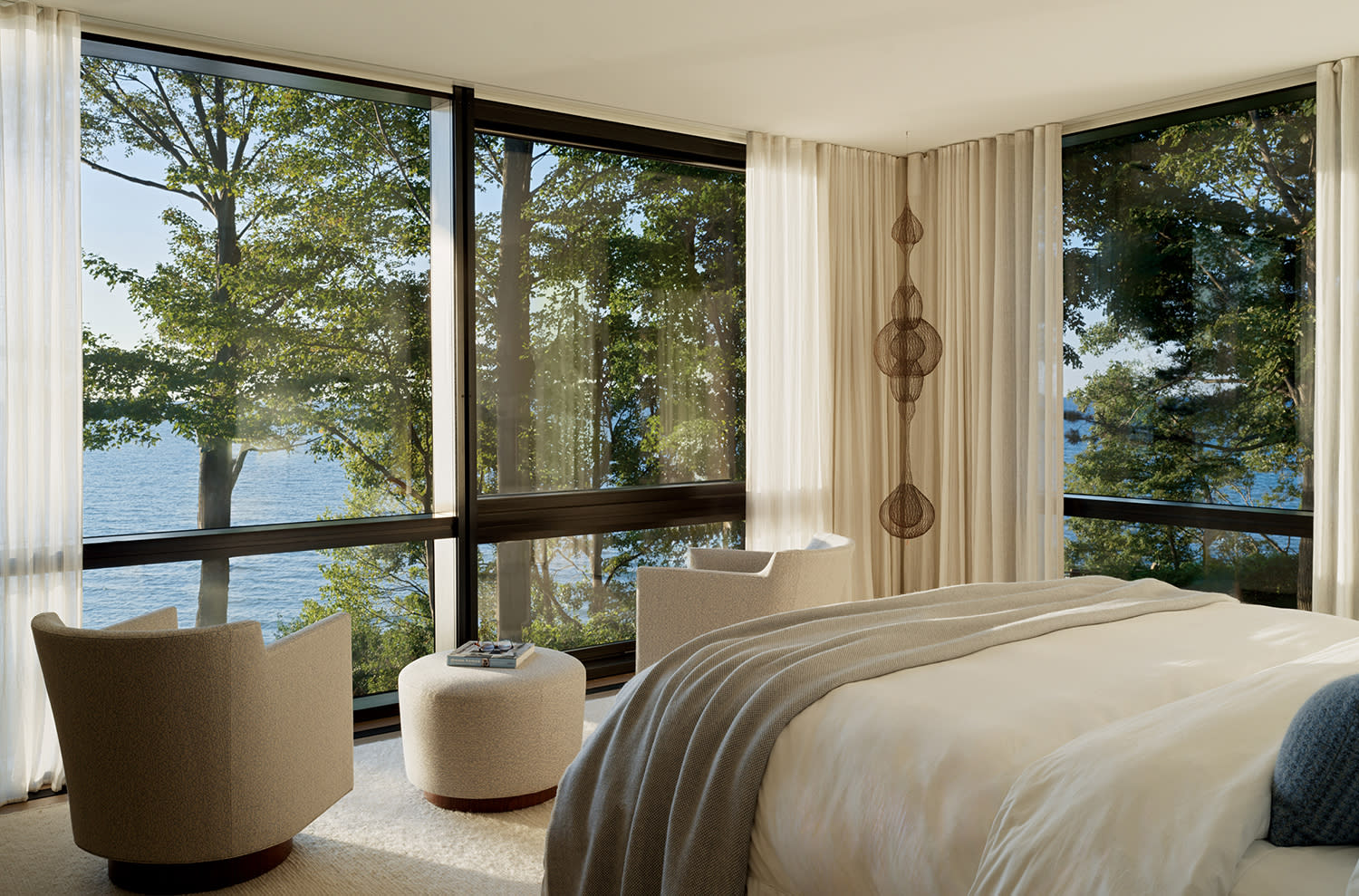 contemporary bedroom with glass walls covered by sheer draperies