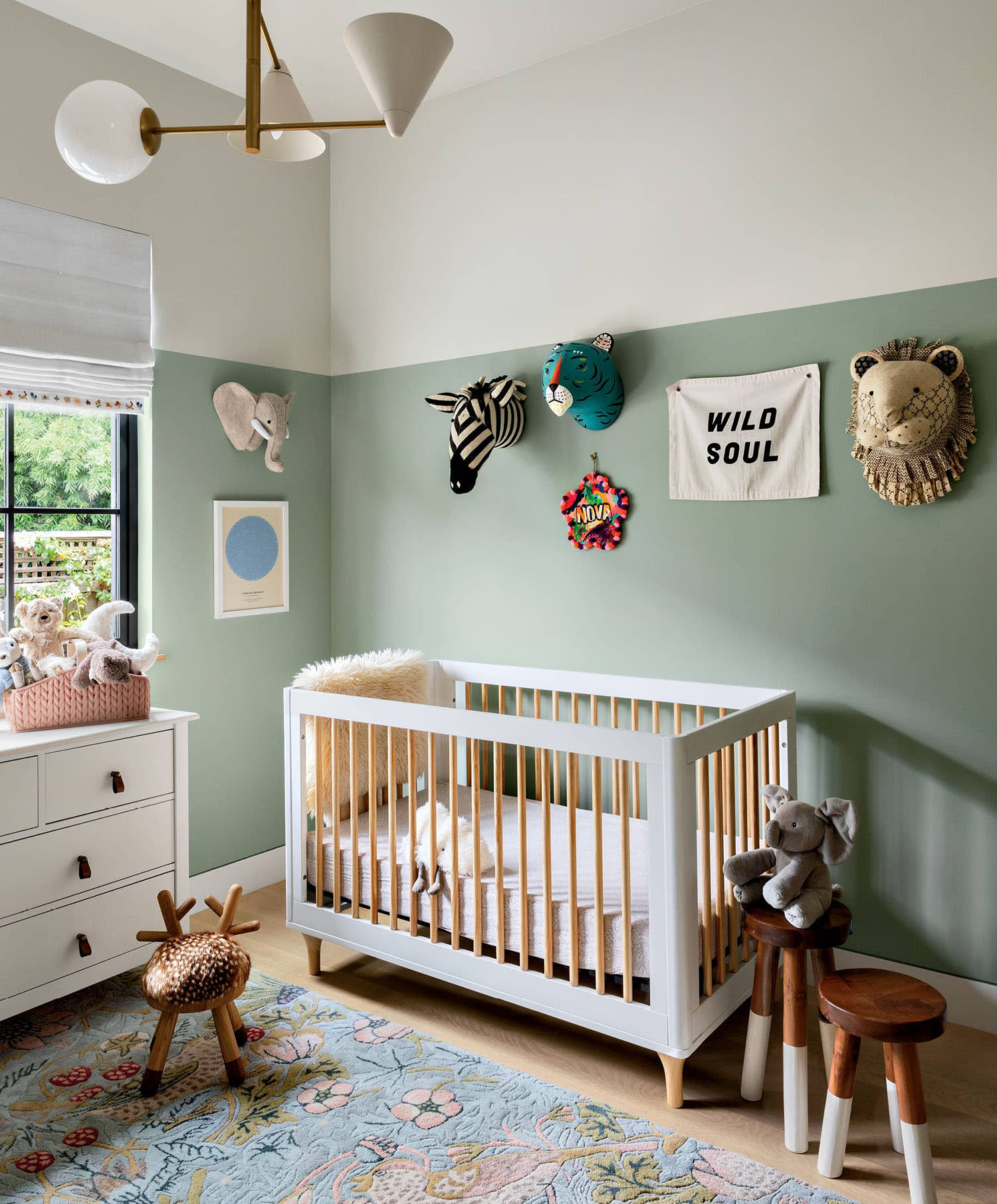 subtle zoo-themed nursery with light green and white walls