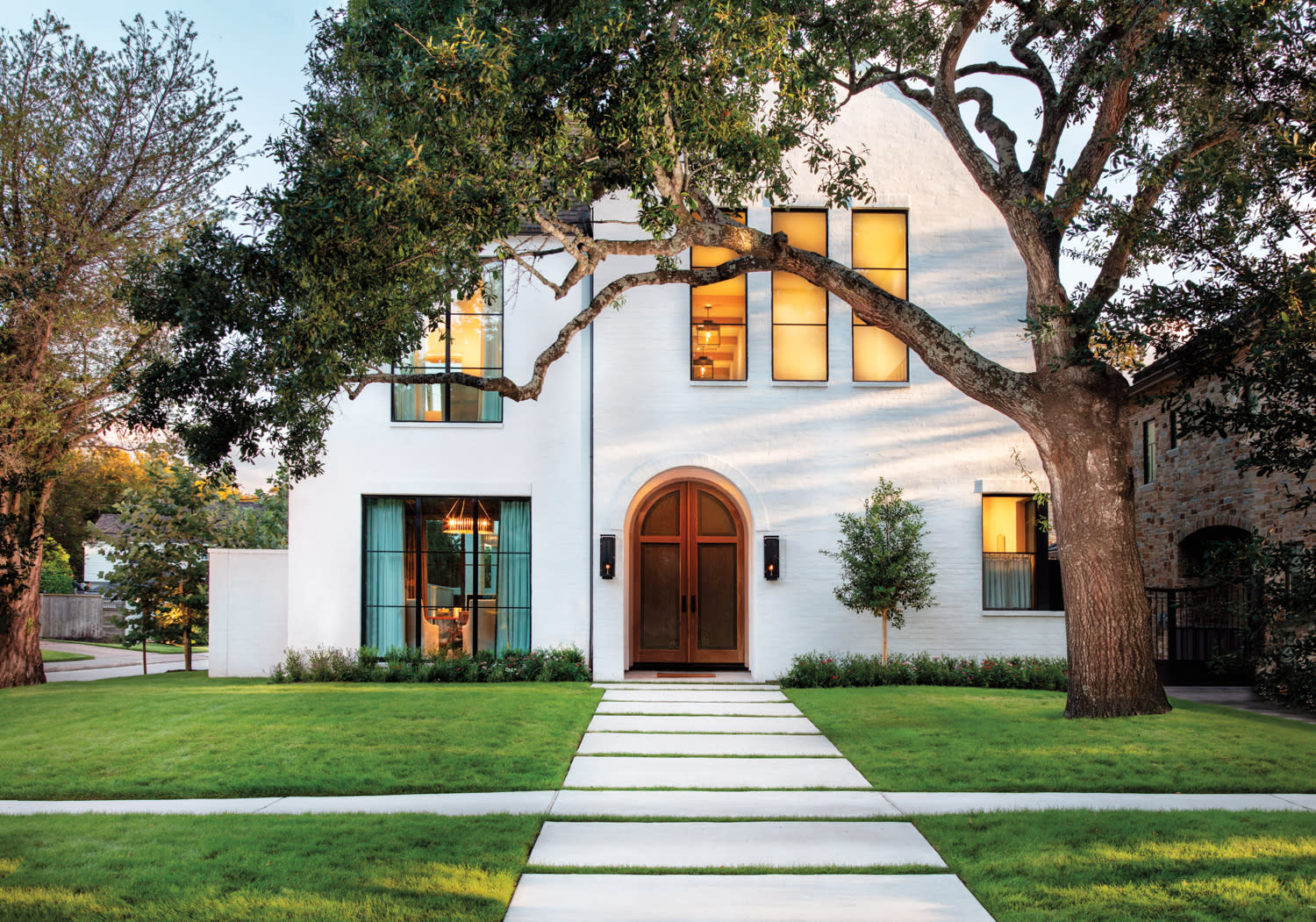 Exterior of a home built by Wimmel Design & Construction on a grassy lot with large trees