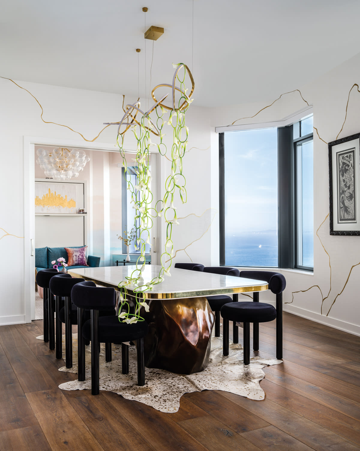 A dining table has large brass legs.