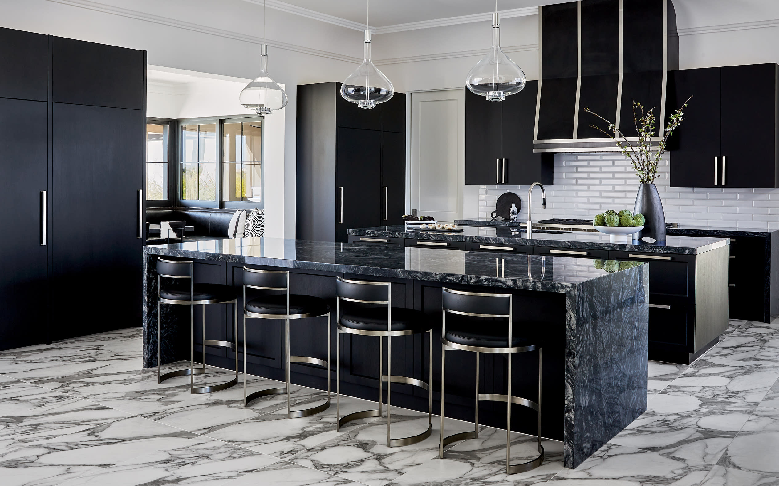 contemporary kitchen with black cabinetry, black hood, and black quartzite island