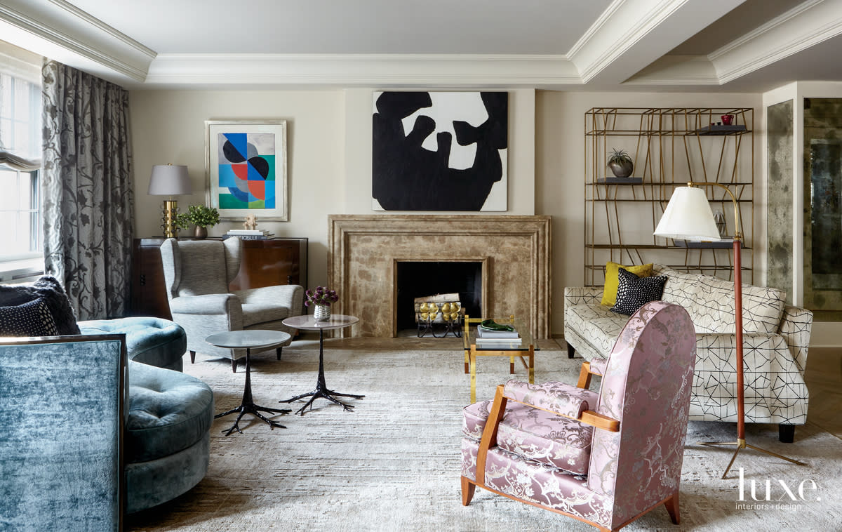 esigner Robert Marinelli merged classic and contemporary sensibilities in Marcee Smith's Upper East Side apartment. A pair of sofas from his RM Furnishings collection anchors the living area. The open shelving is by Dimore Studio from The Future Perfect. Underfoot is a custom carpet by Woven; above the mantel is a work by Jack Youngerman." title="Carnegie Hill NYC apartment; Robert Marinelli